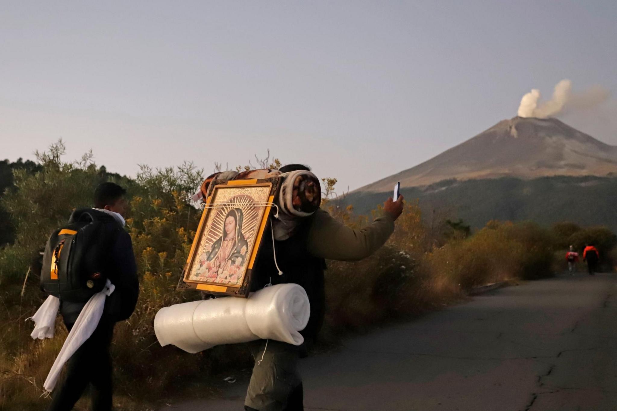 Pilgrims walk towards the Basilica of Guadalupe along the Paso de Cortes, in Puebla, Mexico