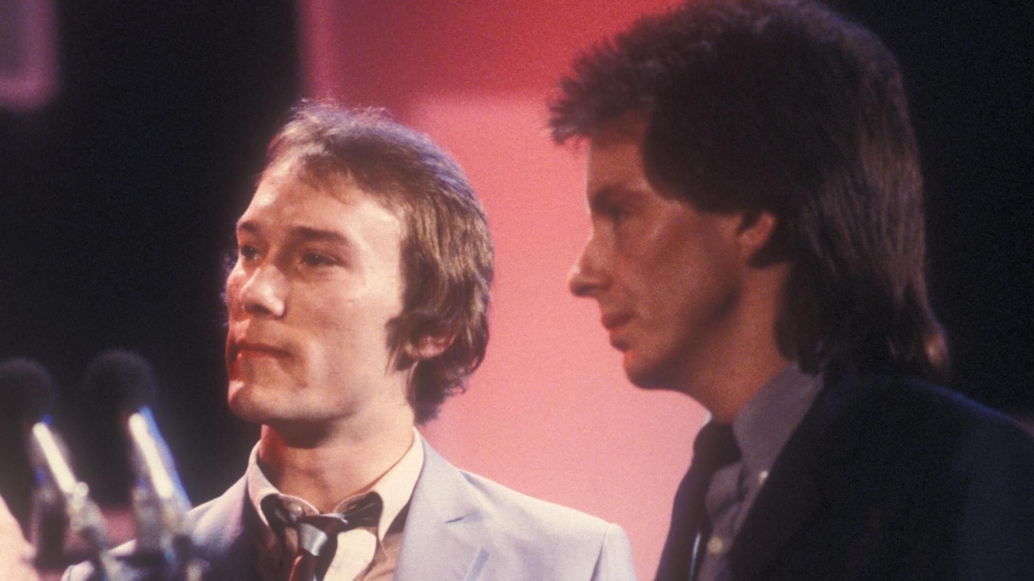 Rick Buckler and Bruce Foxton, wearing suits and ties