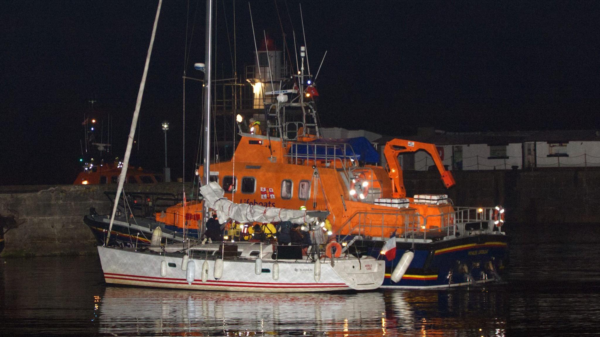 The yacht rafted to a lifeboat in Newlyn harbour during the evening