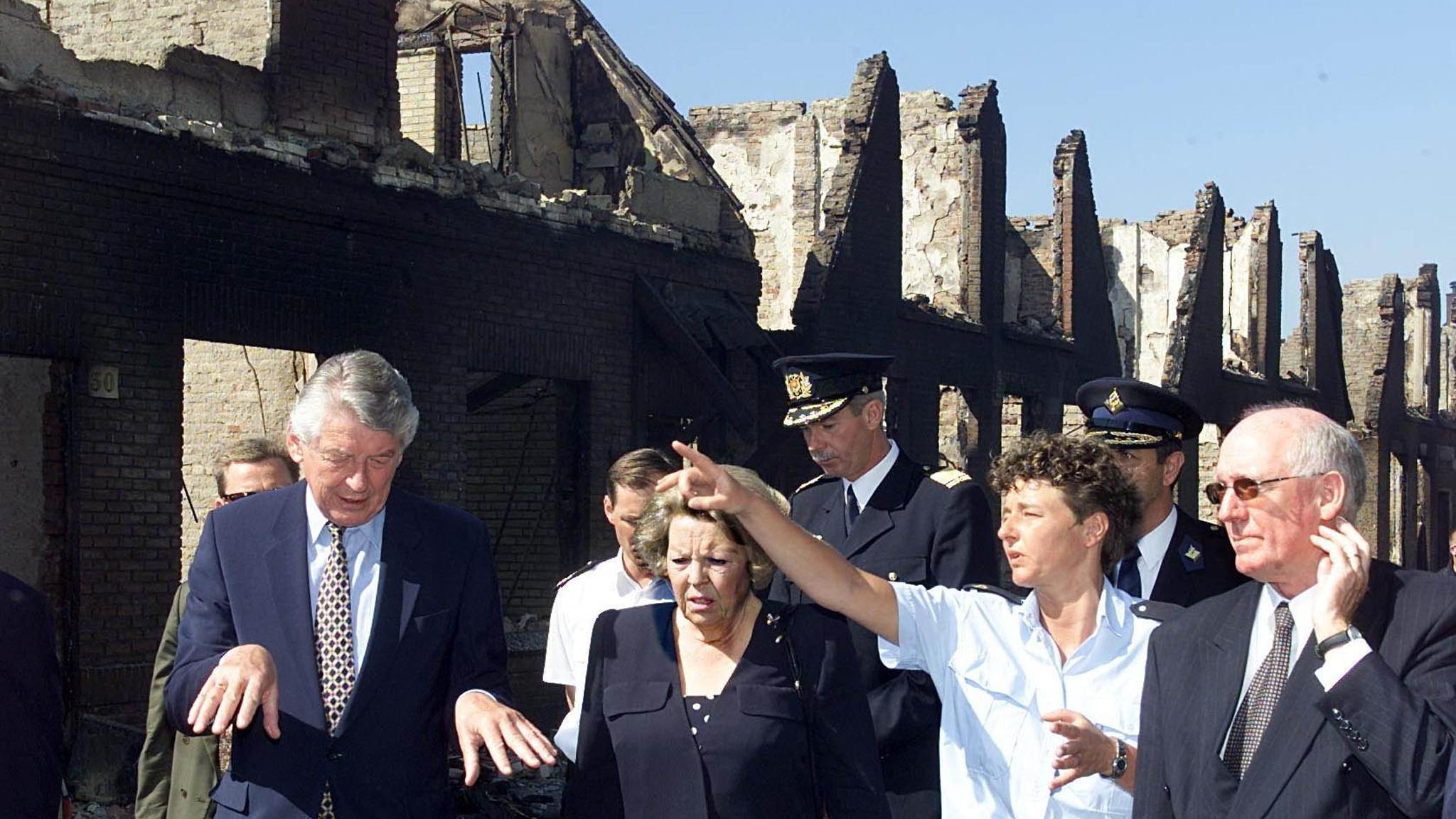 The Enschede fireworks disaster killed 23, destroyed 400 homes and damaged 1,500 buildings. Then Dutch Prime Minister Wim Kok (left) and Queen Beatrix (second left) visited the city of Enschede a year on