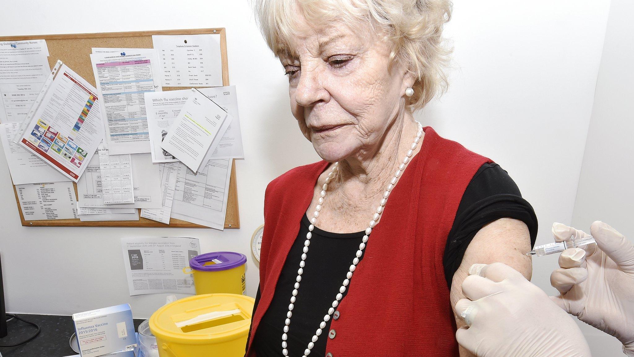 Old woman being getting the jab