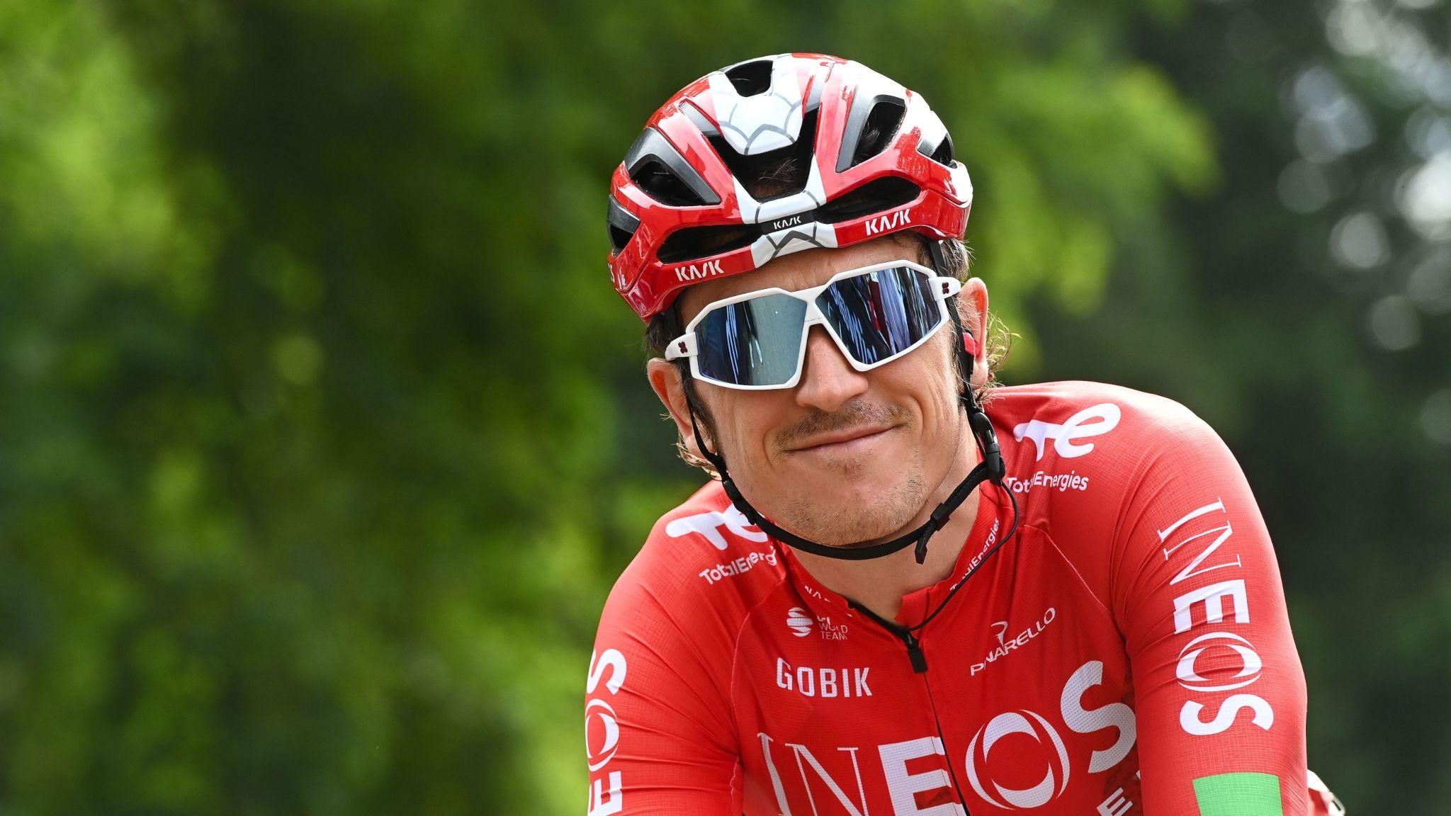 Geraint Thomas wearing sunglasses smiles whilst riding