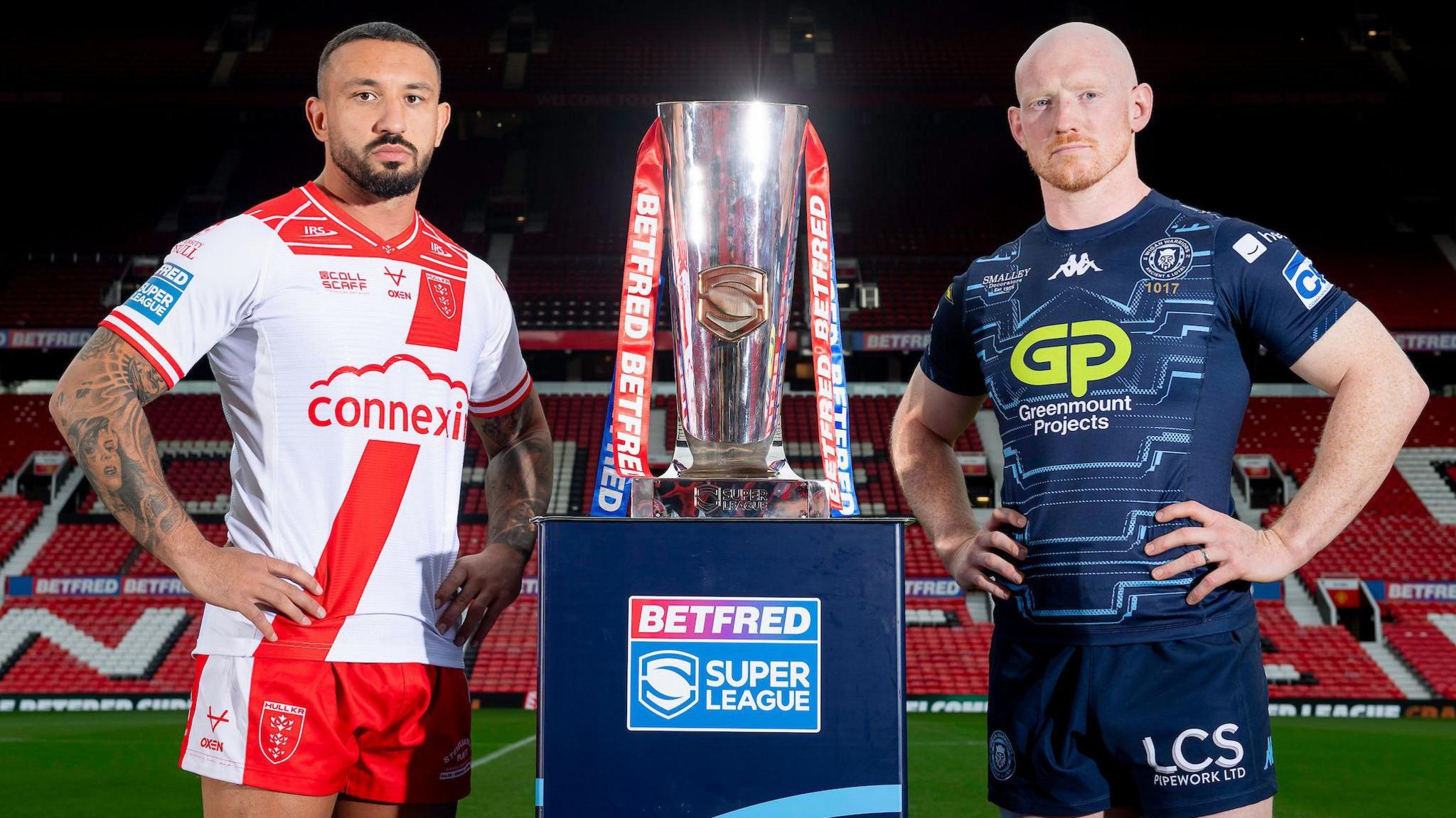 Hull KR's Elliott Minchella and Wigan Warriors' Liam Farrell stand aside the Super League trophy at Old Trafford ahead of this Saturday's Super League Grand Final