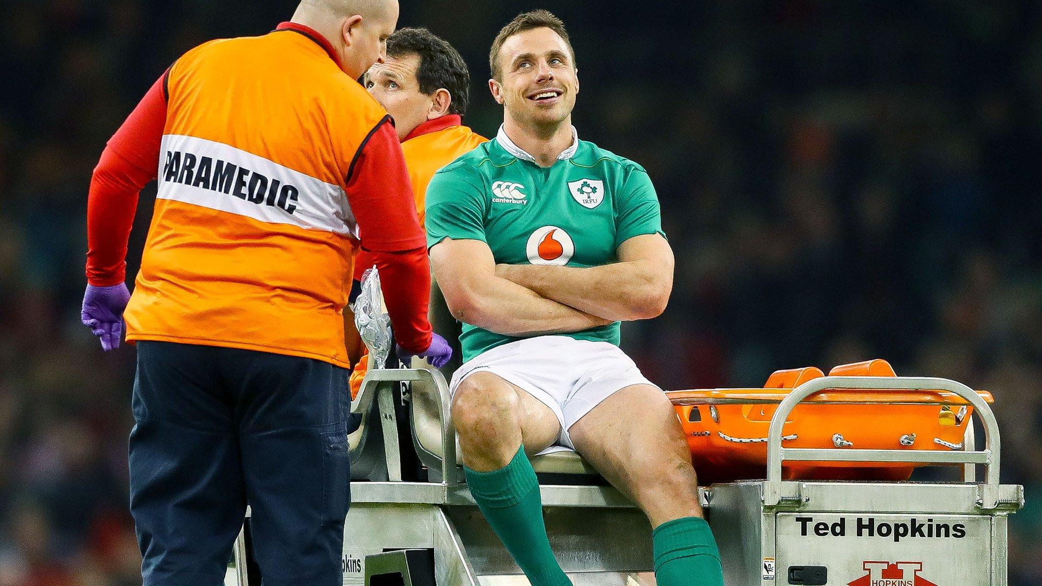 Tommy Bowe manages a smile as he is transported from the pitch