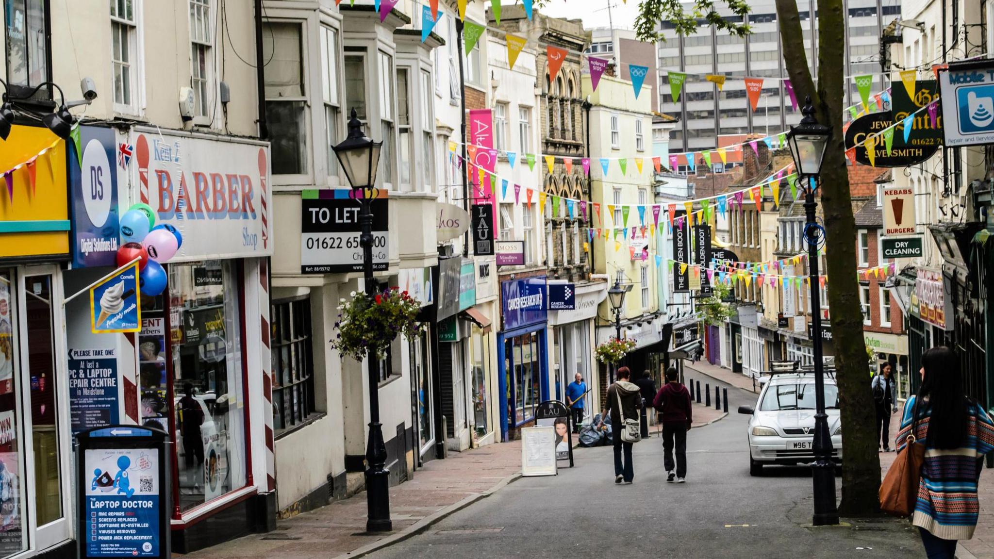 Gabriels Hill, a quaint row of terraced Victorian era shops, flying flags to support London 2012 on the day the Olympic Torch relay came to town."
