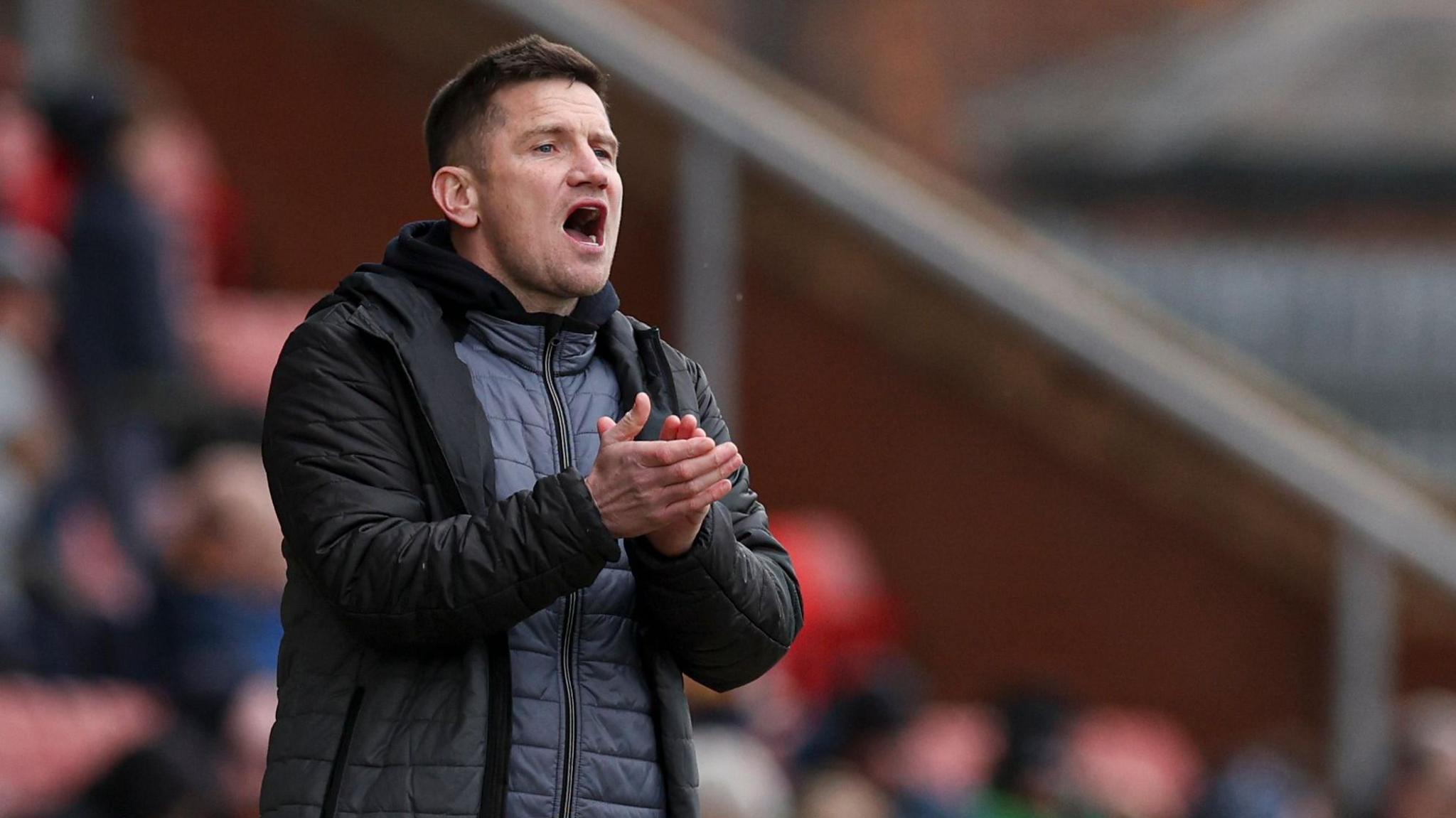 Crewe Alexandra manager Lee Bell shouts from the touchline during a game