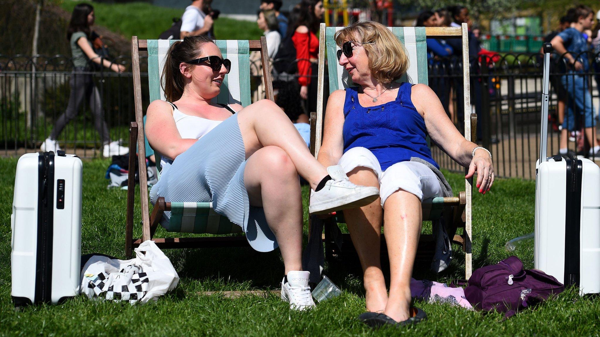 Two women on deck chairs in Green Park