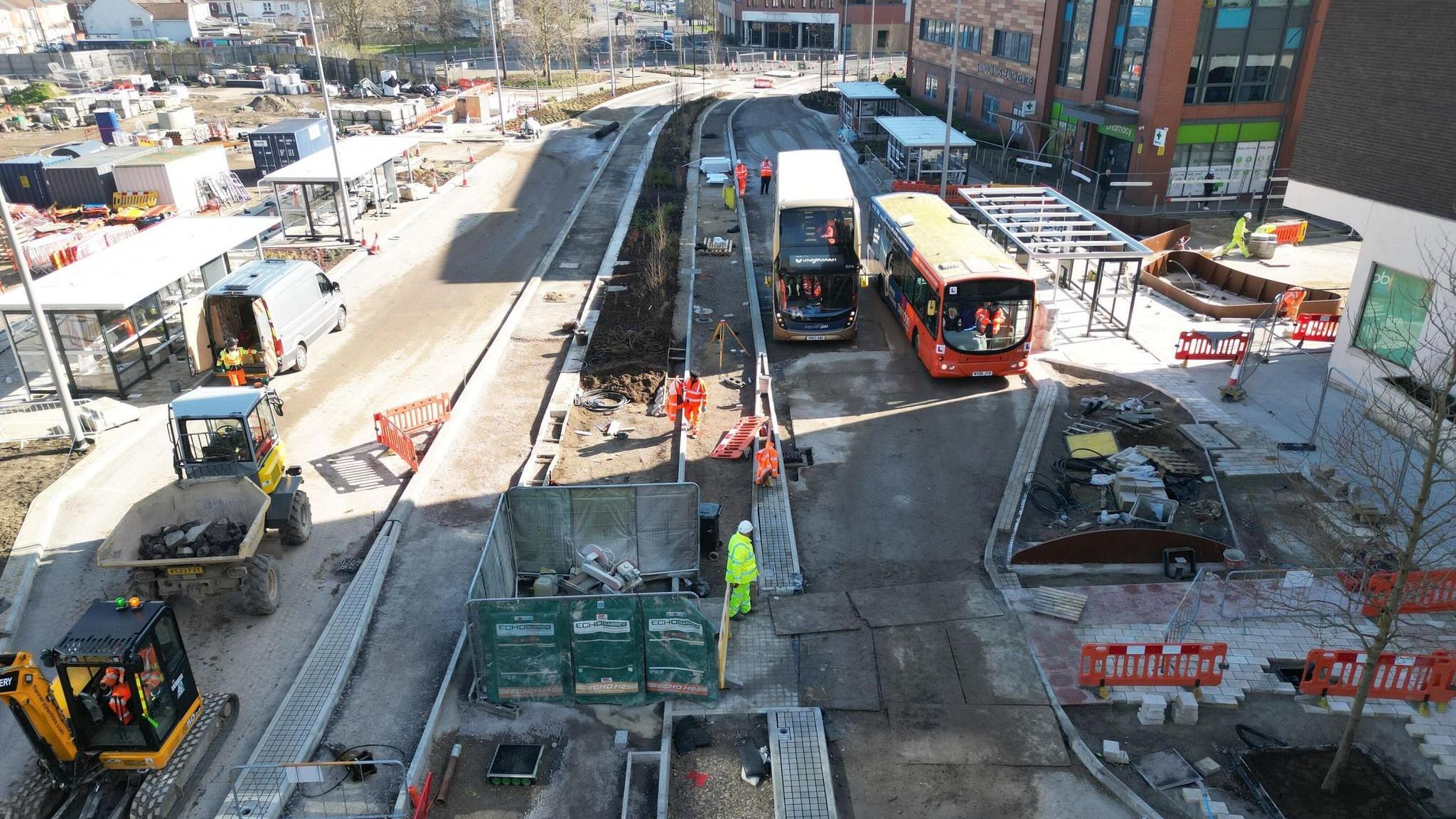 An aerial picture of construction work as two buses try out part of the road