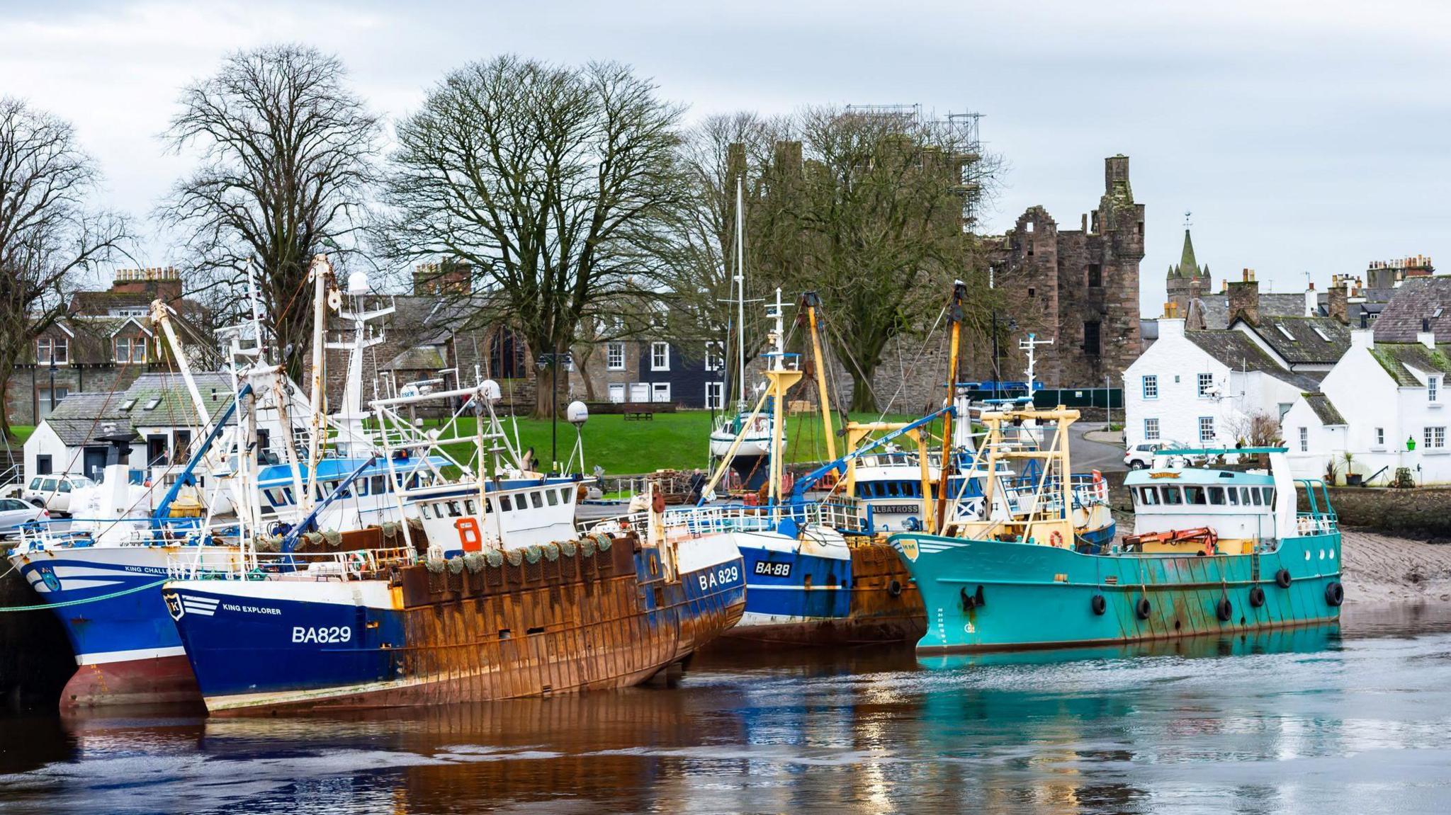 Scallop dredging boats tied up in the harbour of the fishing port of Kirkcudbright