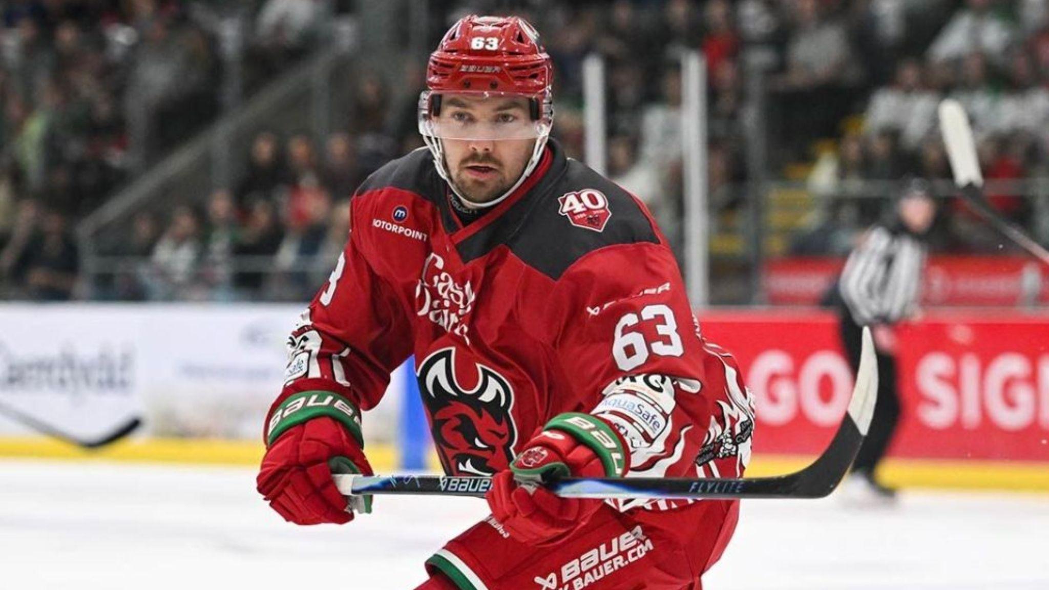 Panu Mieho playing for Cardiff Devils in red jersey and shorts