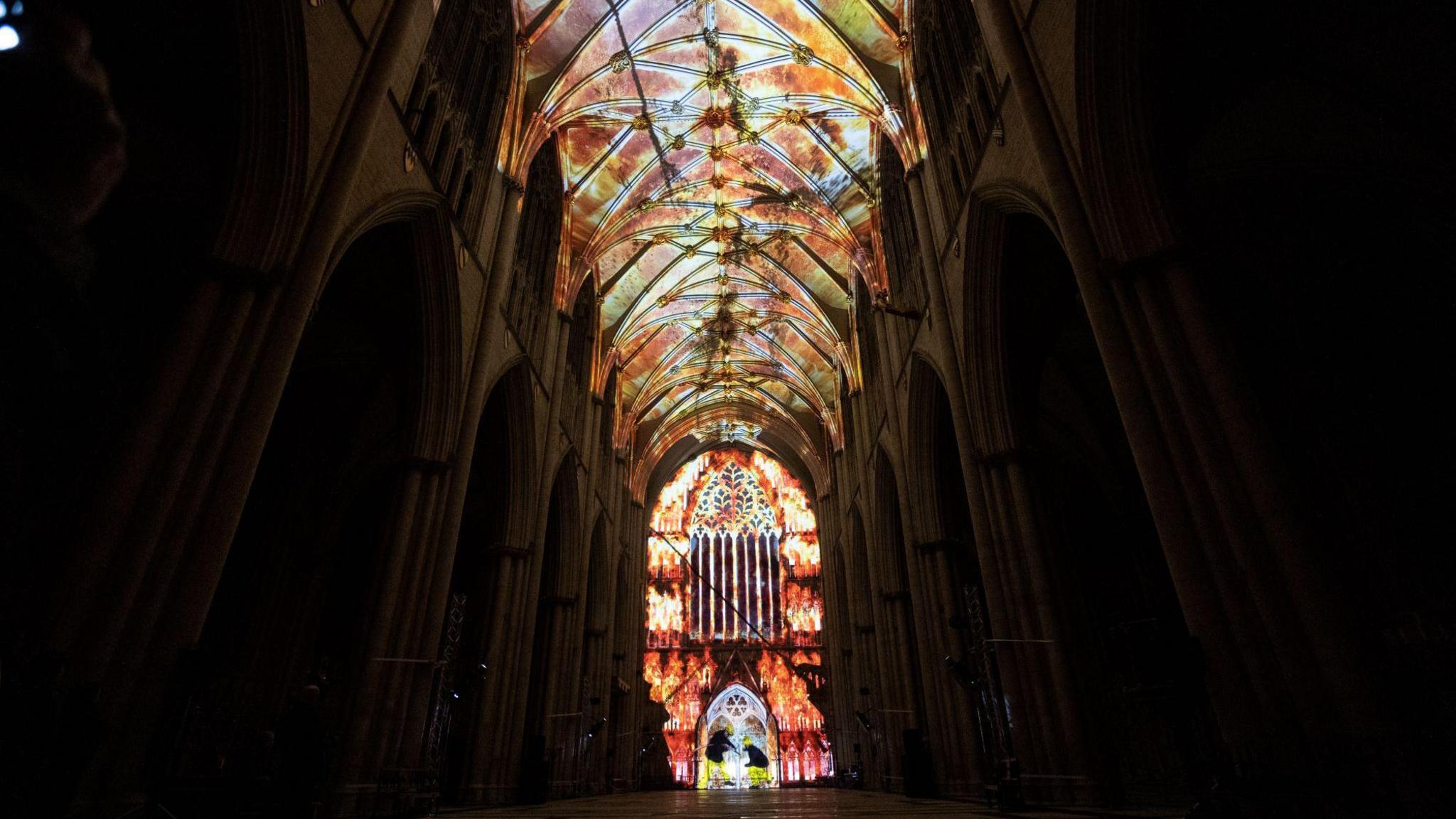 A full view of the art installation, where flames light up the nave and west end of York Minster