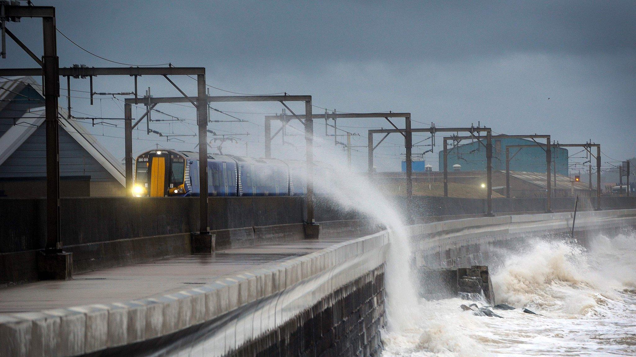 Train passes through waves at Saltcoats in North Ayrshire