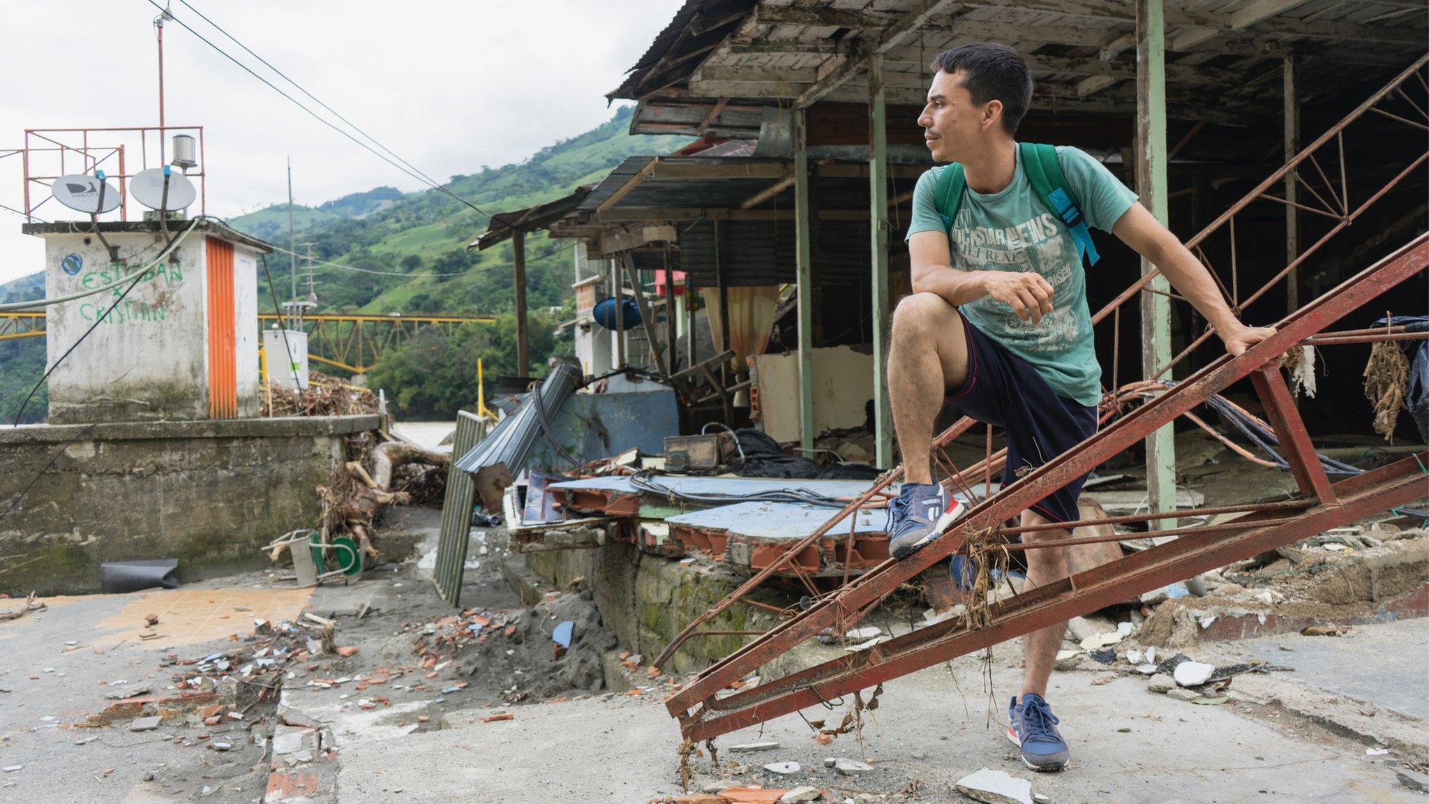 A man stands by the ruins of a building near Ituango in Colombia