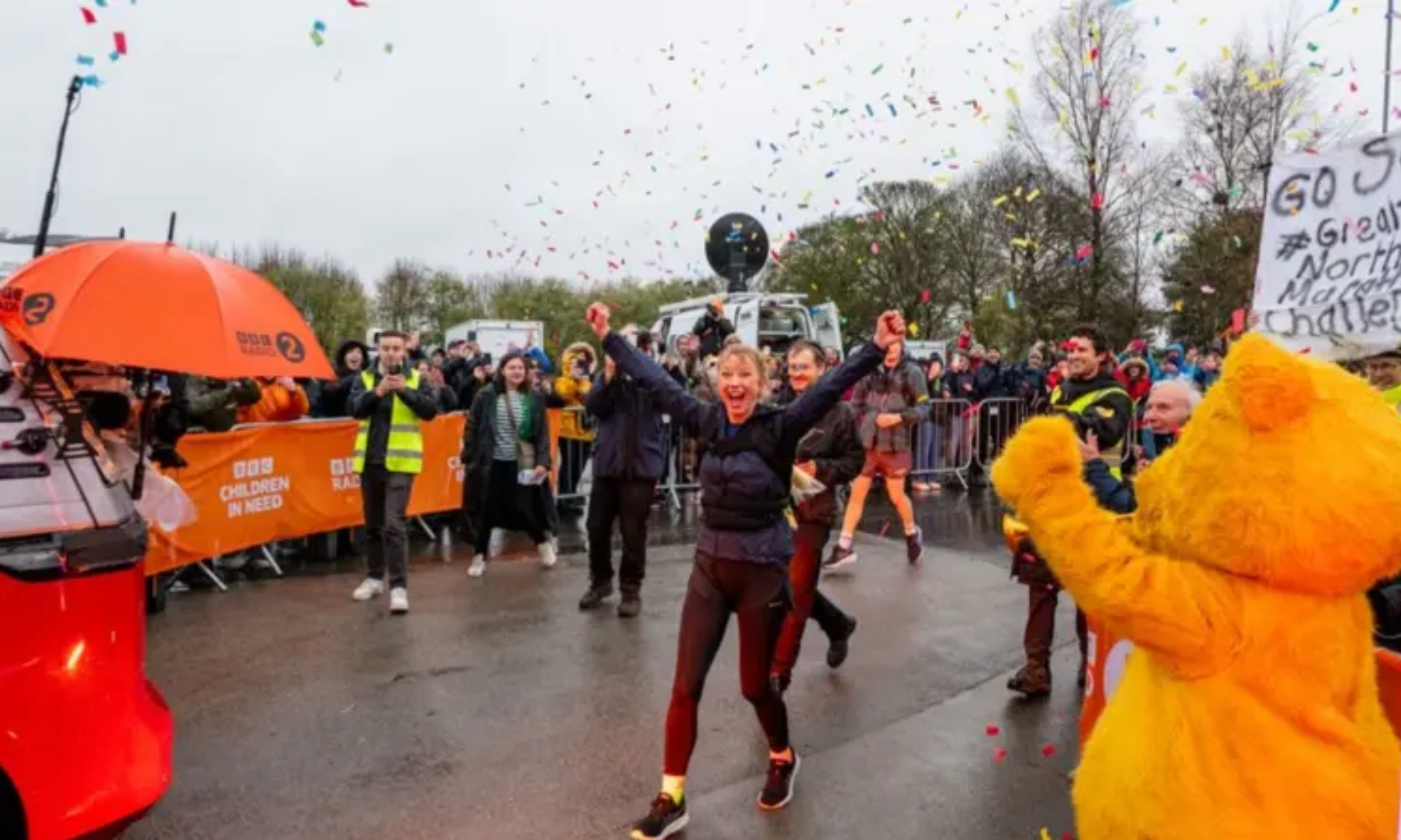 Sara Cox is seen celebrating after reaching the finish line 