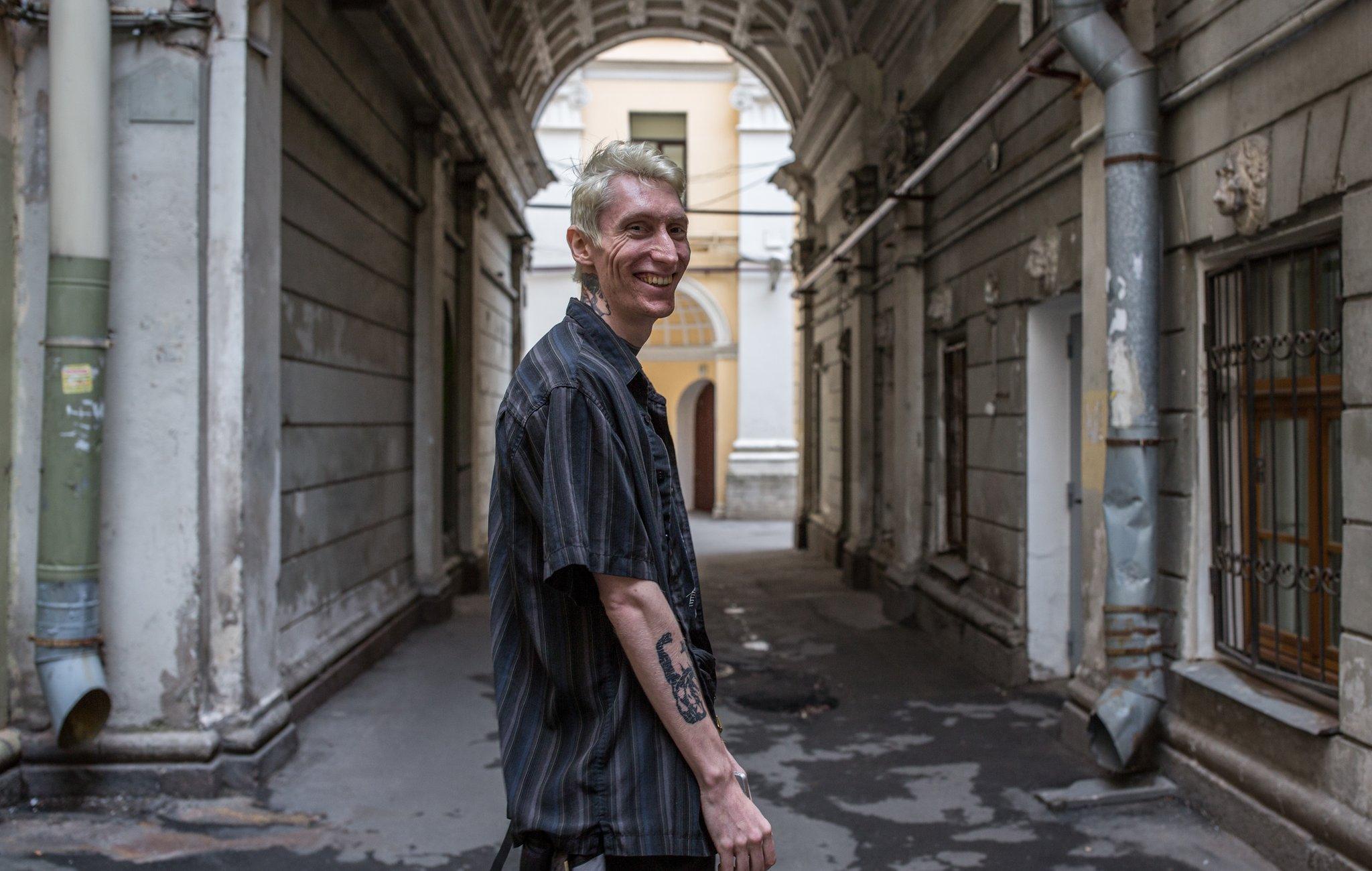 Kostya smiling beneath an archway