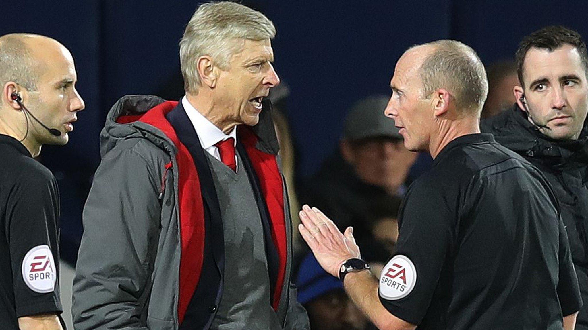 Arsenal manager Arsene Wenger (left) and referee Mike Dean