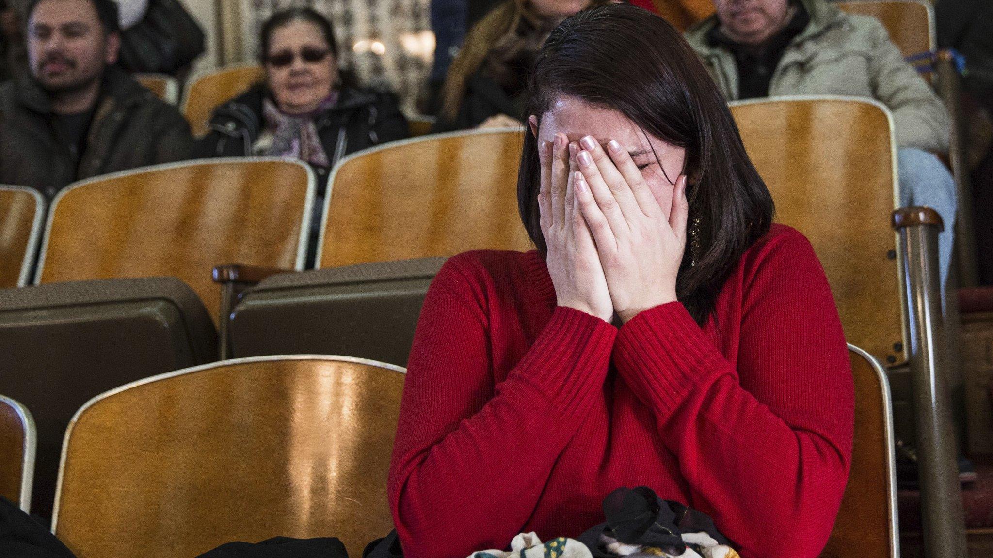 Anne Devlin, from Plano, Texas, cries in the gallery of the House of Representatives after the Electoral College voted at the state Capitol in Austin, Texas