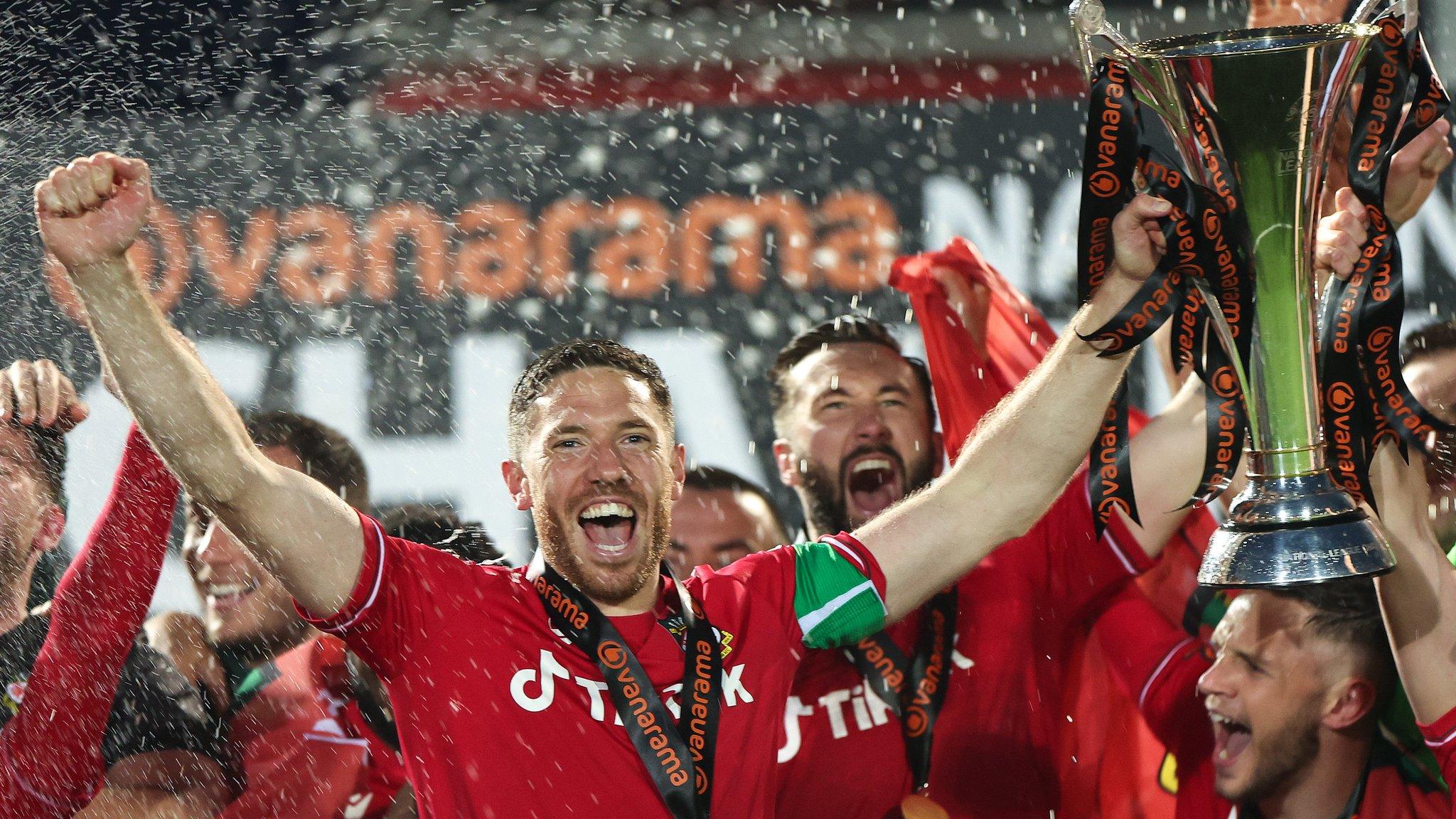 Wrexham's Ben Tozer celebrates with the National League trophy