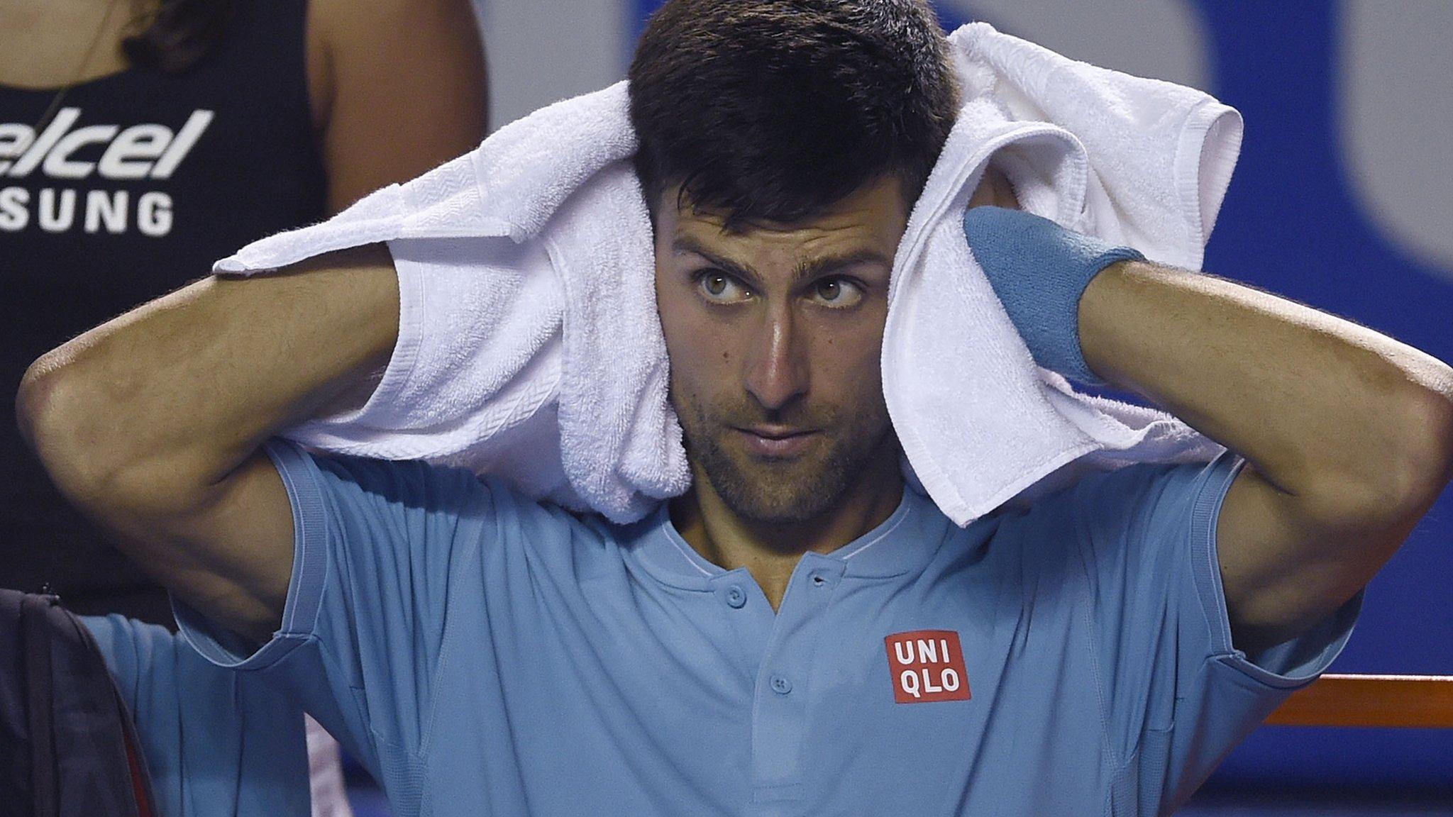 Novak Djokovic rubs his head with a towel during defeat by Nick Kyrgios