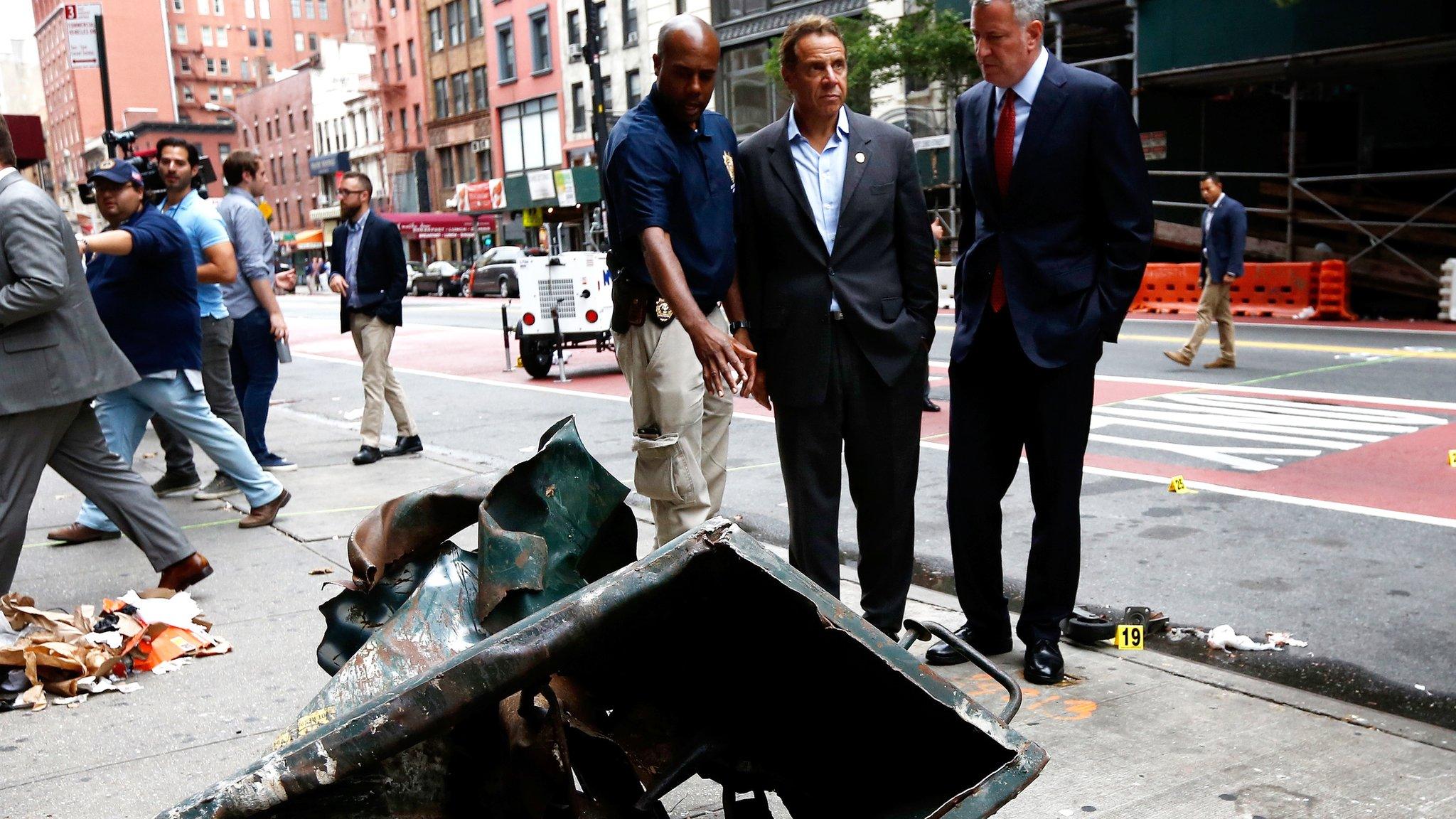 New York Governor Cuomo and Mayor Bill DeBlasio look at explosion site