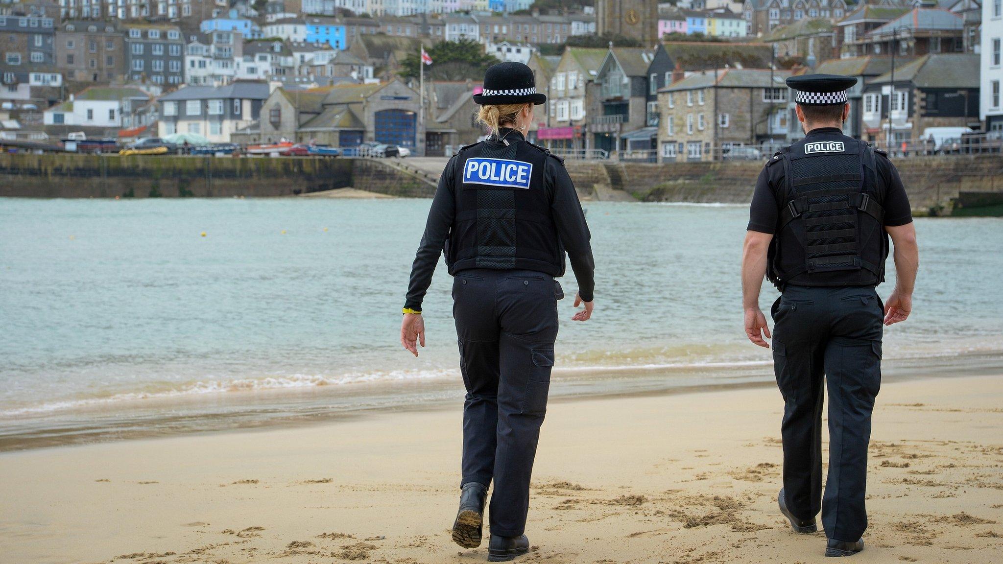 Devon and Cornwall Police officers walking on a beach