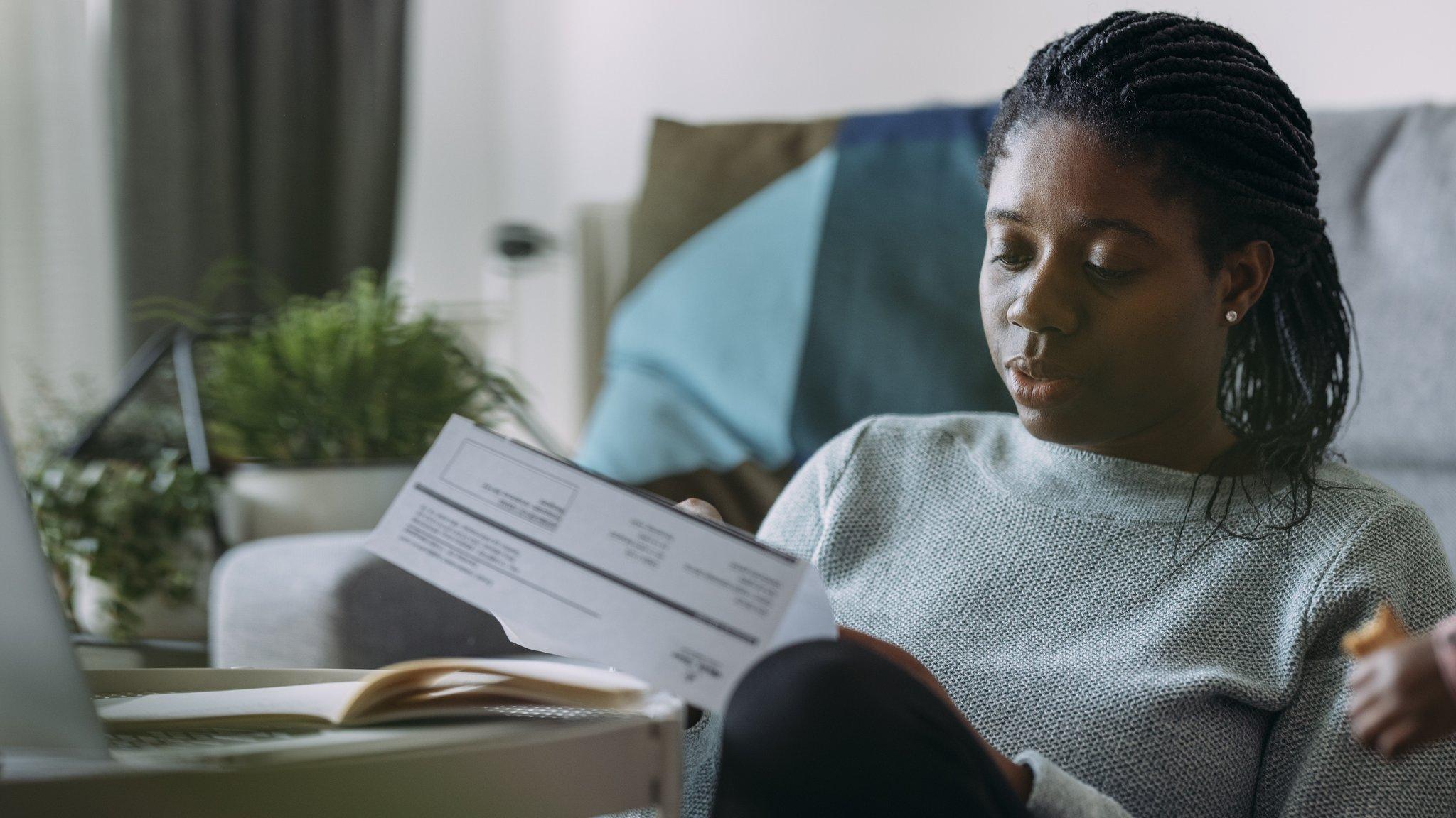 A woman looks concerned about her bills