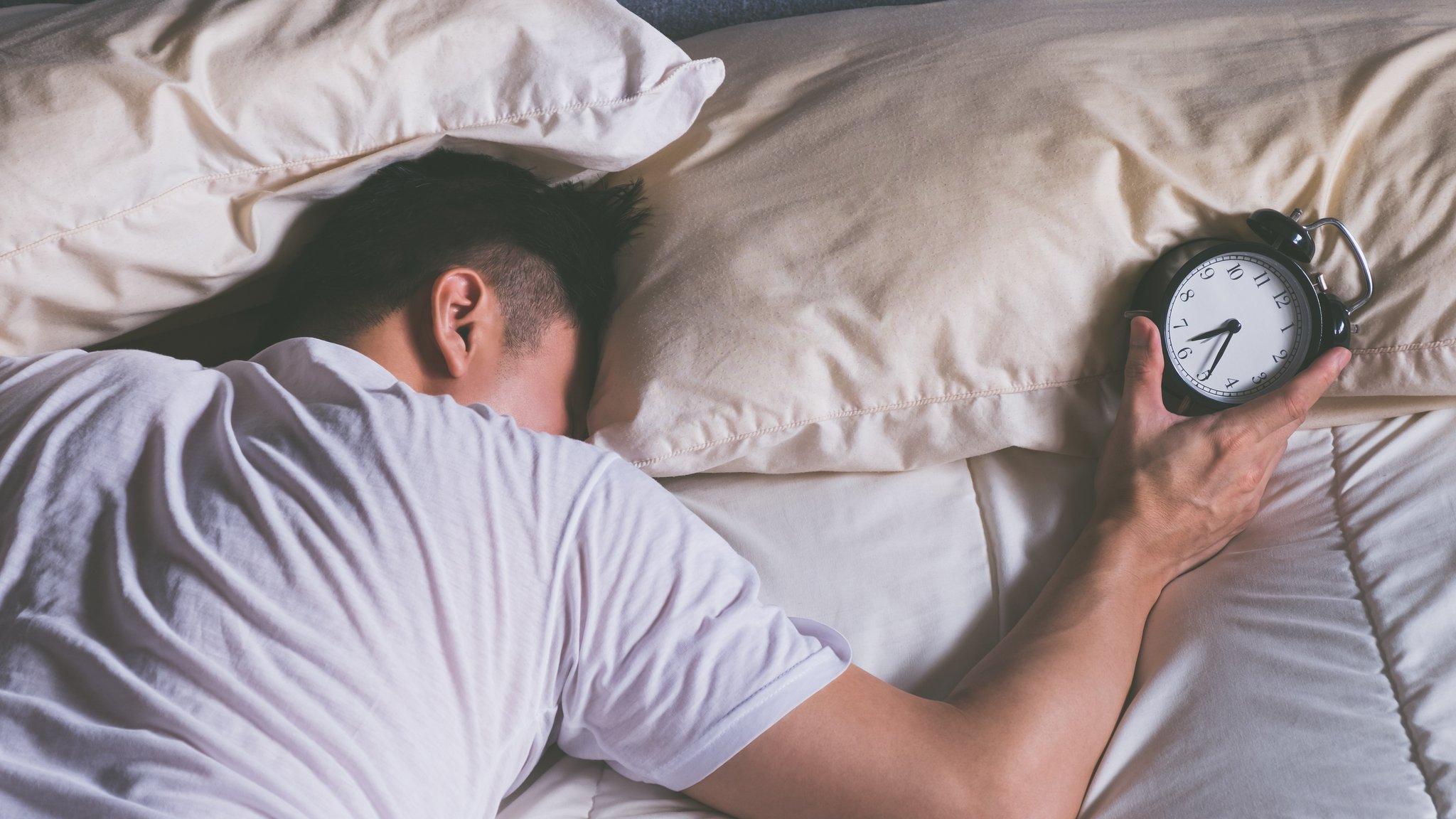 Man holding an alarm clock