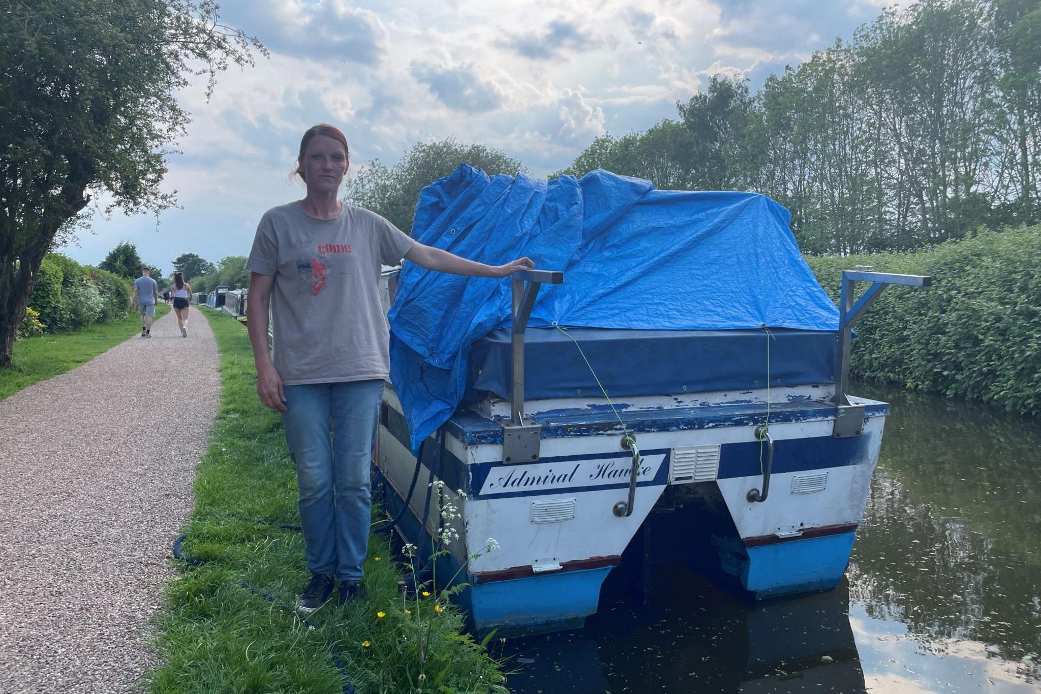 Jolita standing next to her boat