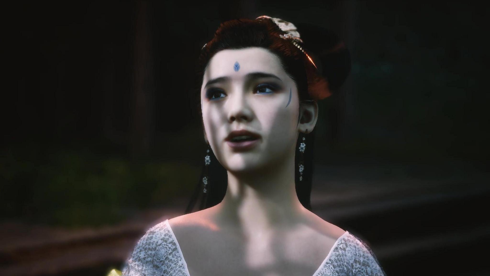 A CGI of a spider sister from the game Black Myth: Wukong. She has intricate blue makeup on her forehead and temples and is wearing a white dress