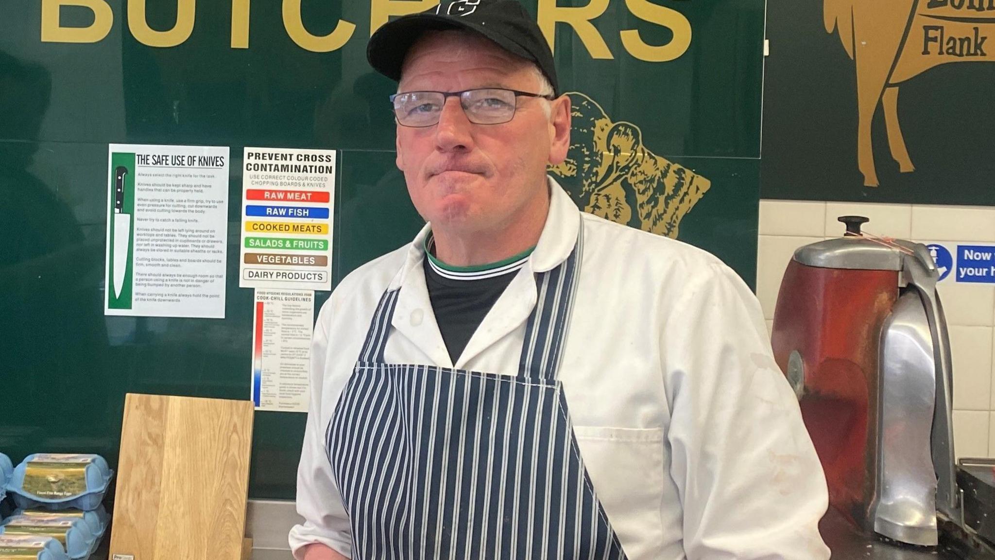 Gerard standing in his butcher's shop behind the counter