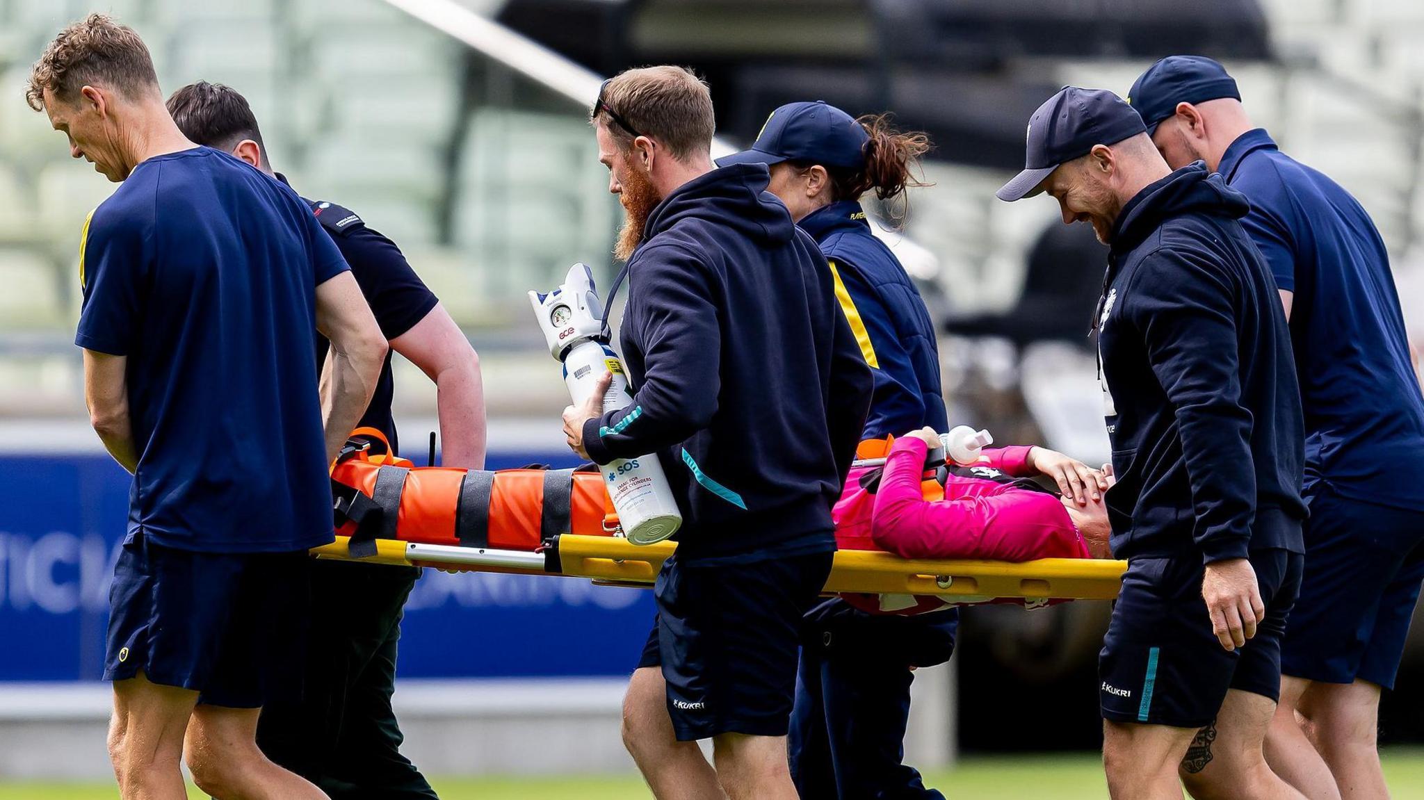Stretcher bearers at Edgbaston carry Somerset player Emma Corney off the field