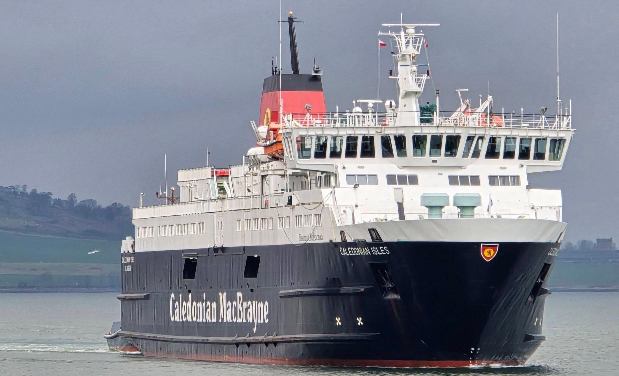 A black and white ship with a red funnel, sailing towards the camera. 