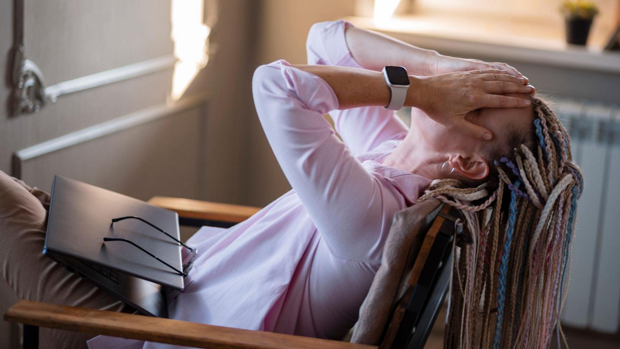 Woman puts head in hands in despair