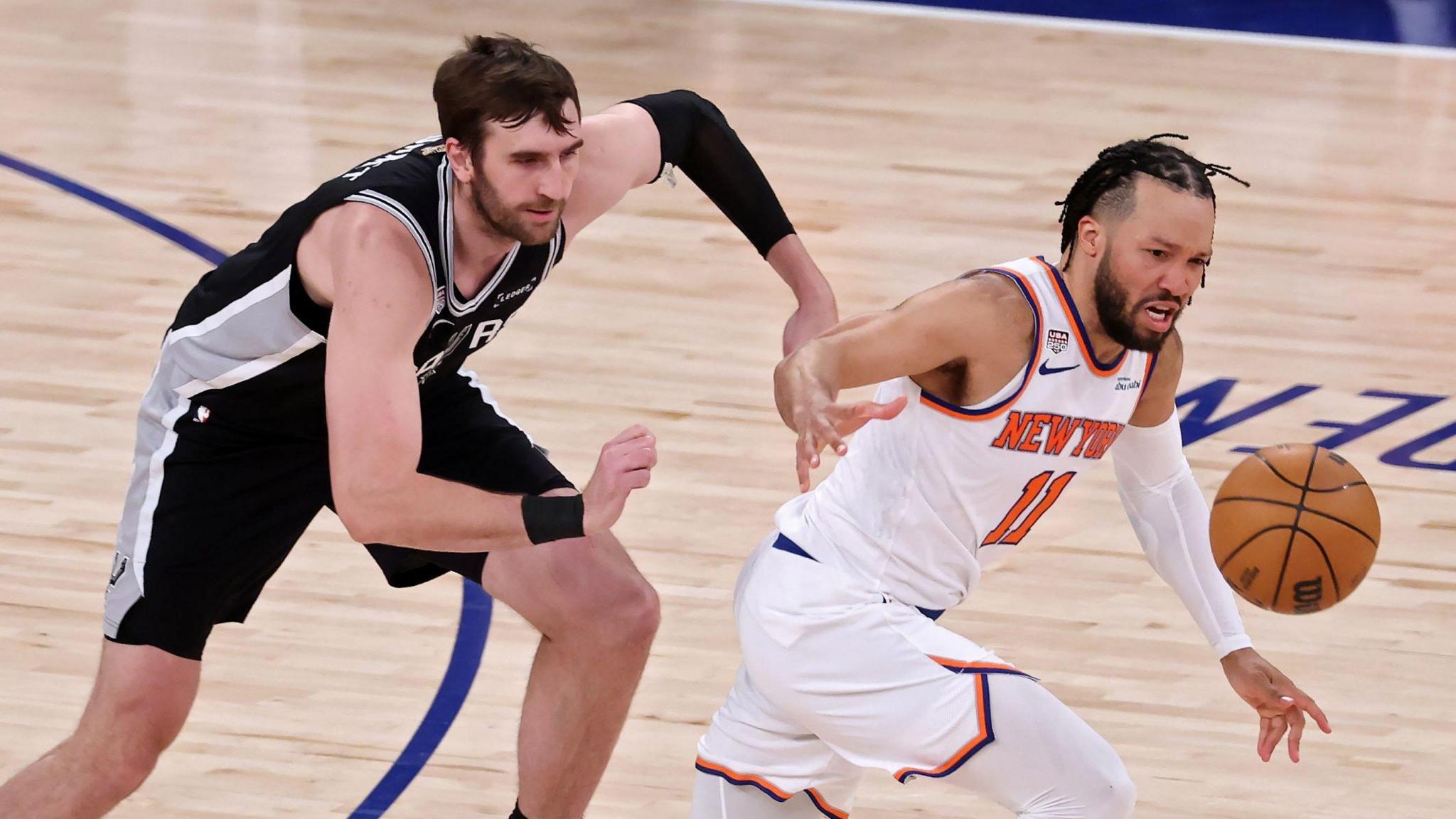 The San Antonio Spurs' Luke Kornet chases the New York Knicks' Jalen Brunson
