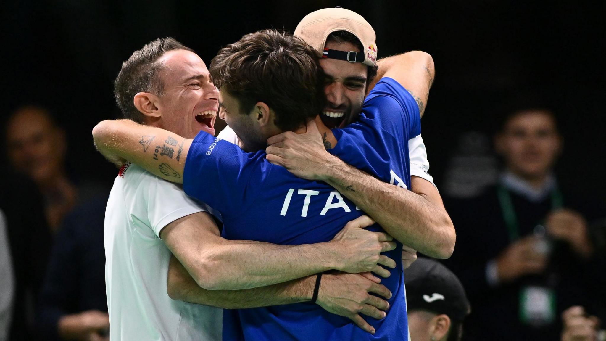 Flavio Cobolli celebrates with team-mate Matteo Berrettini and captain Filippo Volandri 