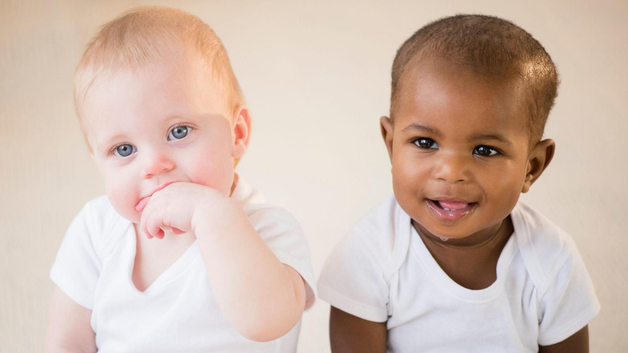 two babies sitting next to each other