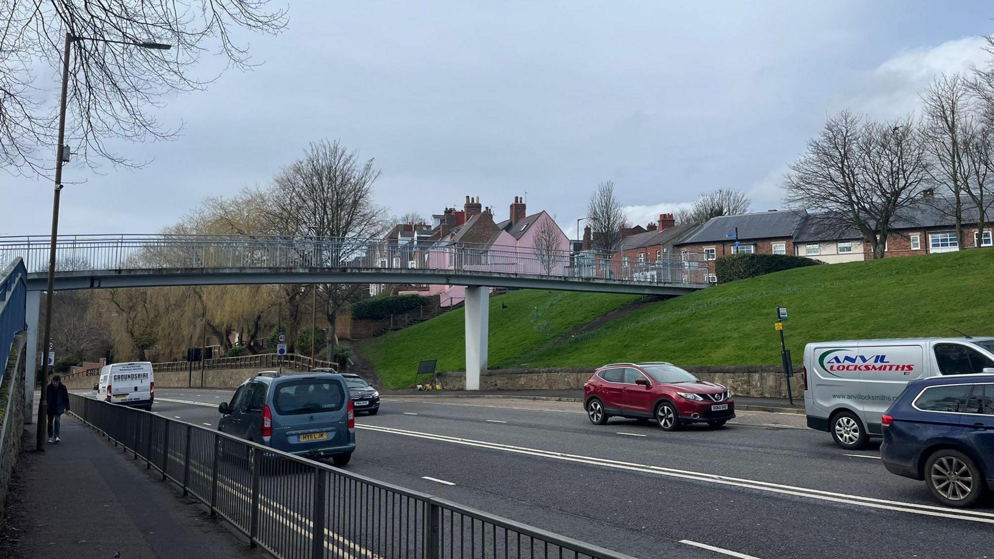 Footbridge over a road with cars on it