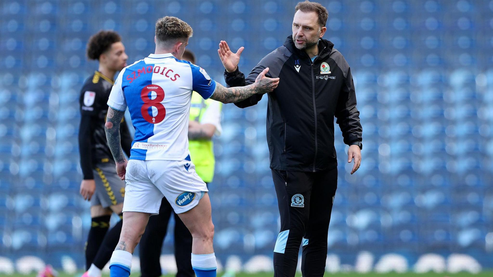 John Eustace shakes the hand of Sammie Szmodics during their time together at Blackburn in 2024