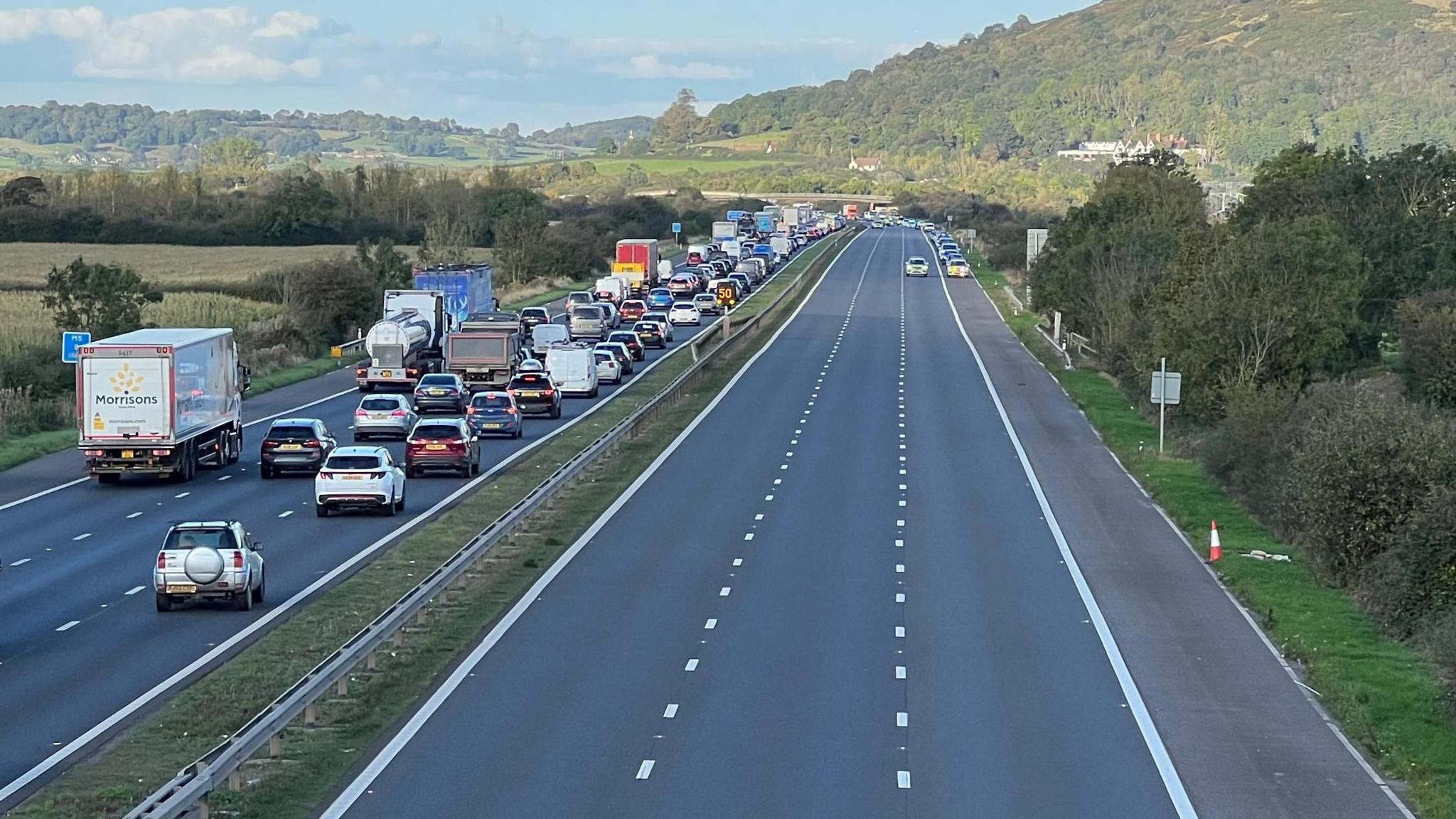 View of the M5 from above. The southbound carriageway is gridlocked, while the northbound carriageway is deserted.