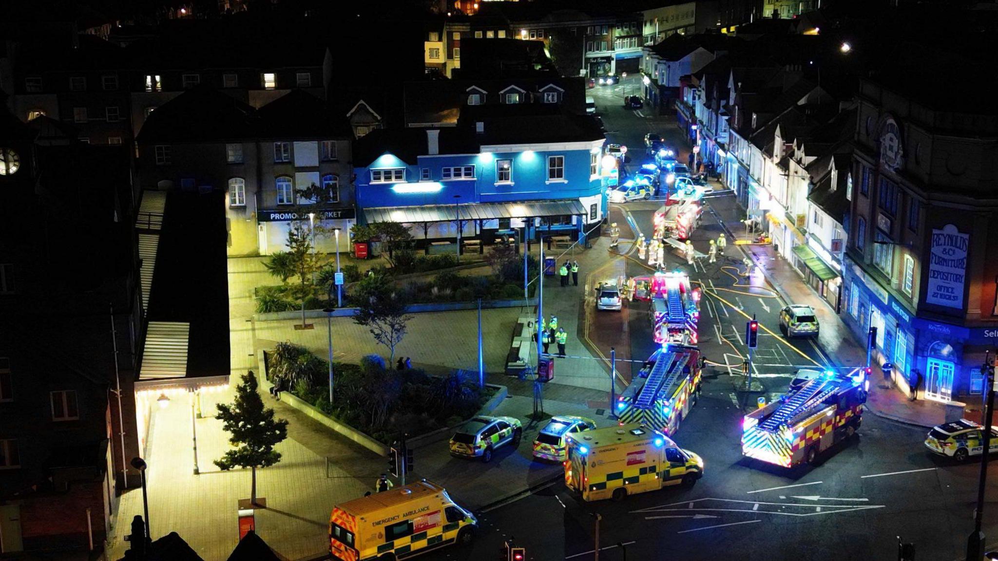 Ambulances, police cars and fire engines, with a cordon around a street, pictured from above at the scene of a fire in Bognor Regis.