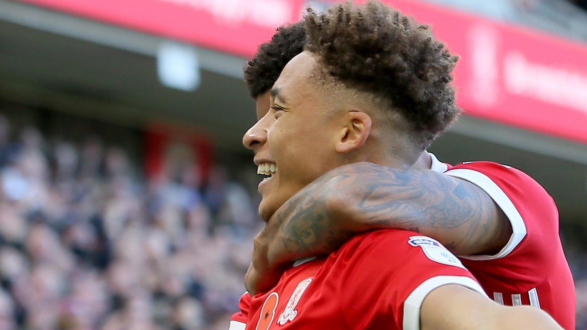 Marcus Tavernier celebrates a goal with a Middlesbrough team-mate in front of fans