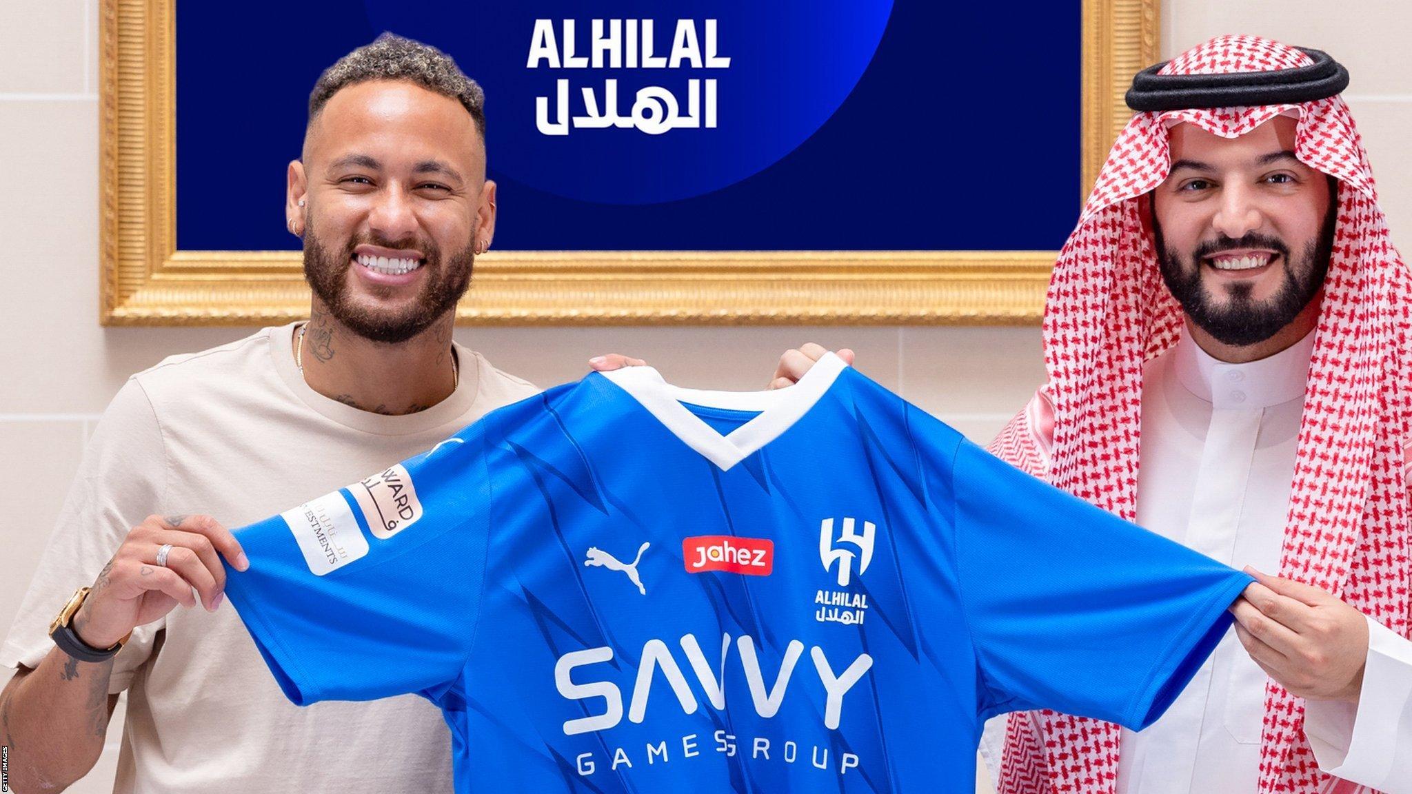 Neymar holds up an Al-Hilal shirt after signing