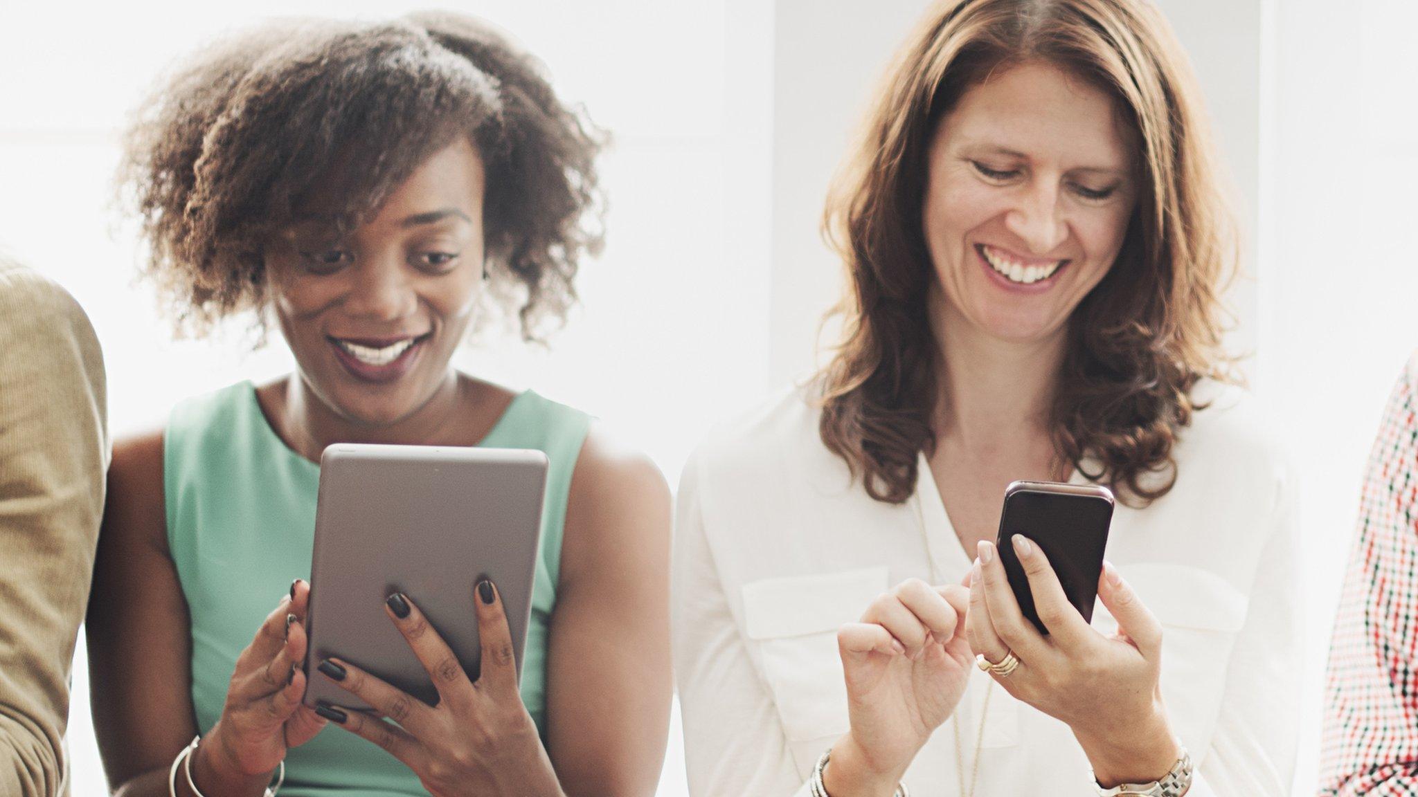 Women reading content on their digital devices