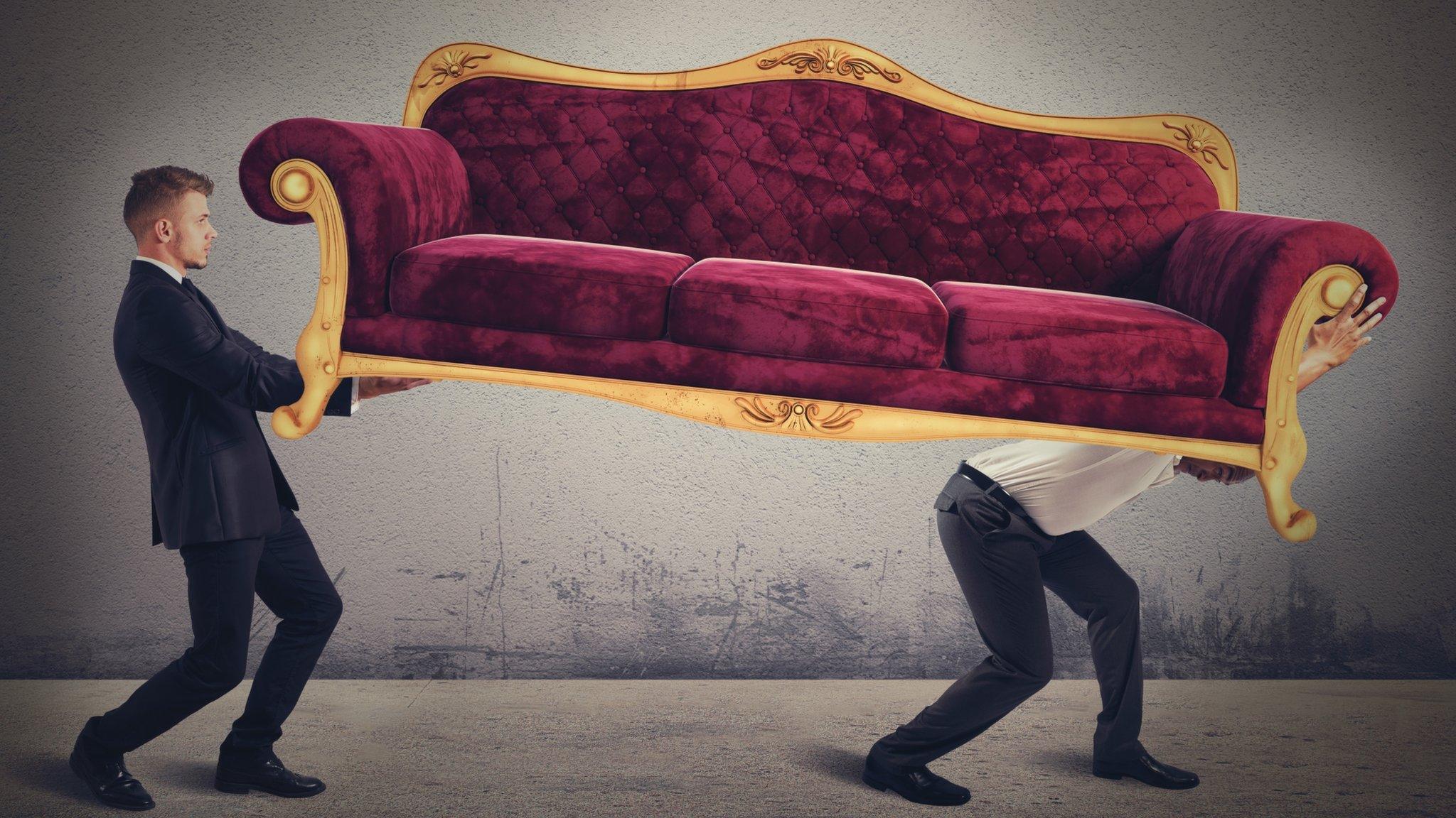 Two men carrying a sofa