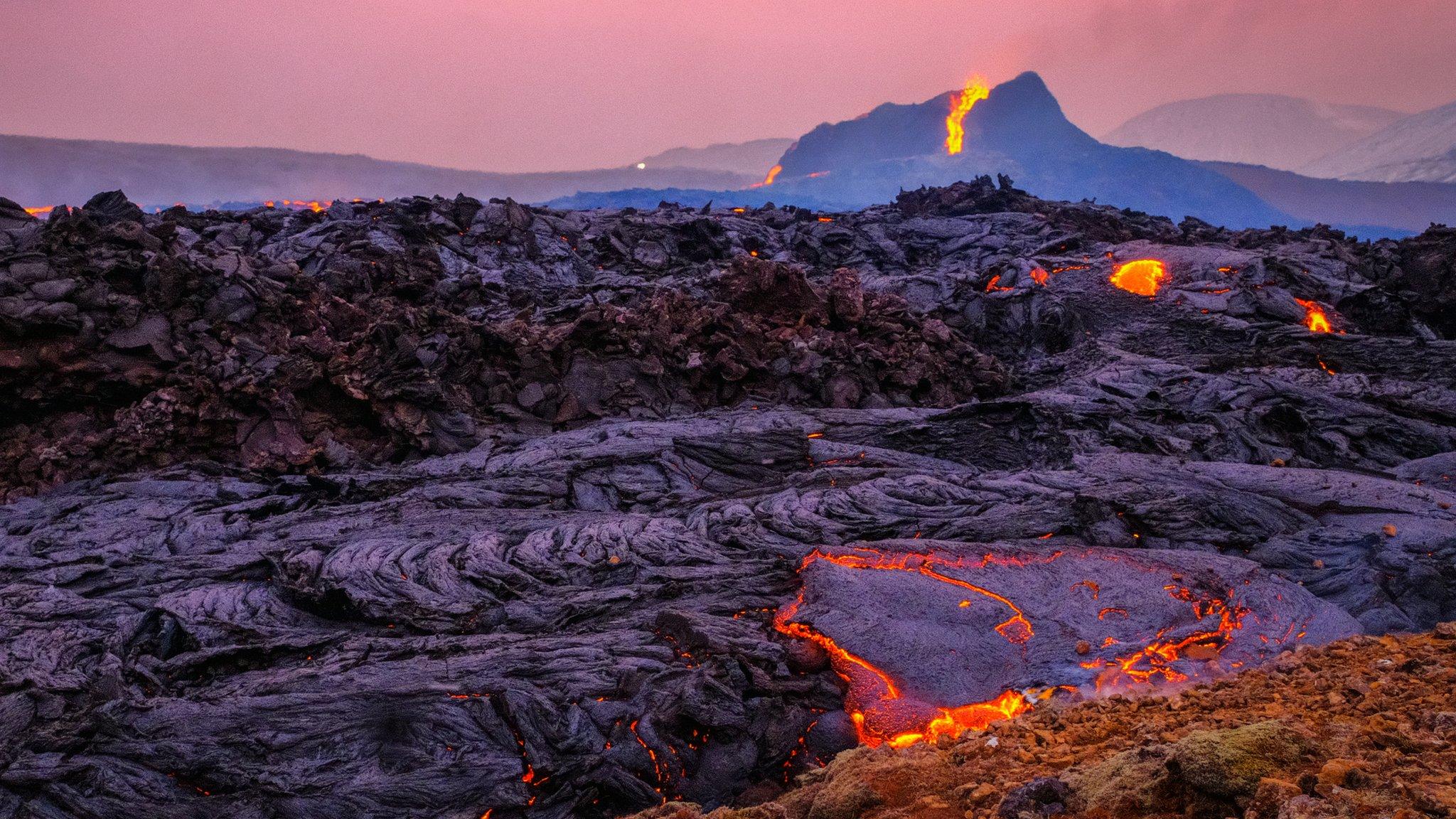 Lava flows at sunset from the erupting Fagradalsfjall volcano in Geldingadalur on March 25, 2021