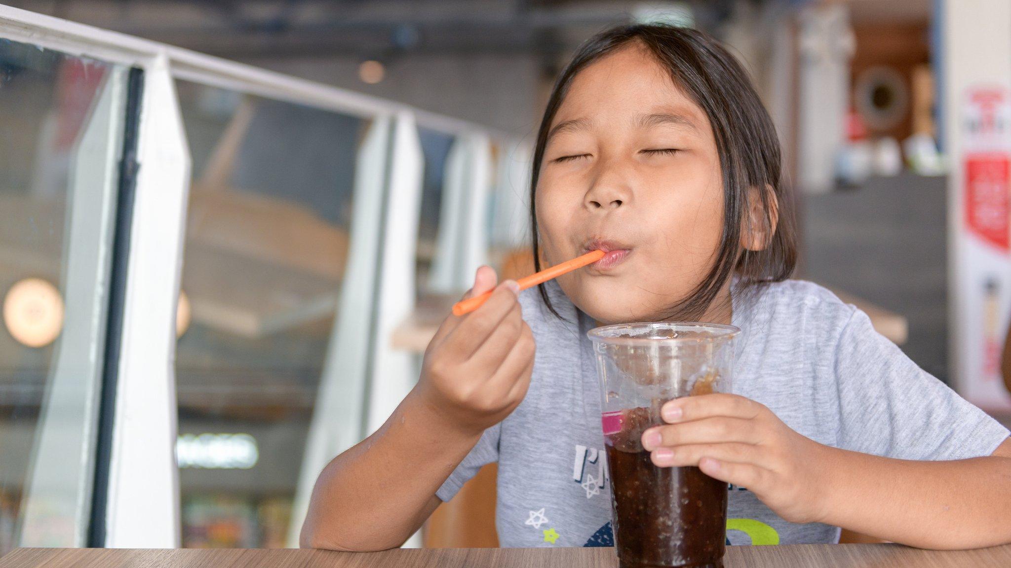 Child with a sugary drink