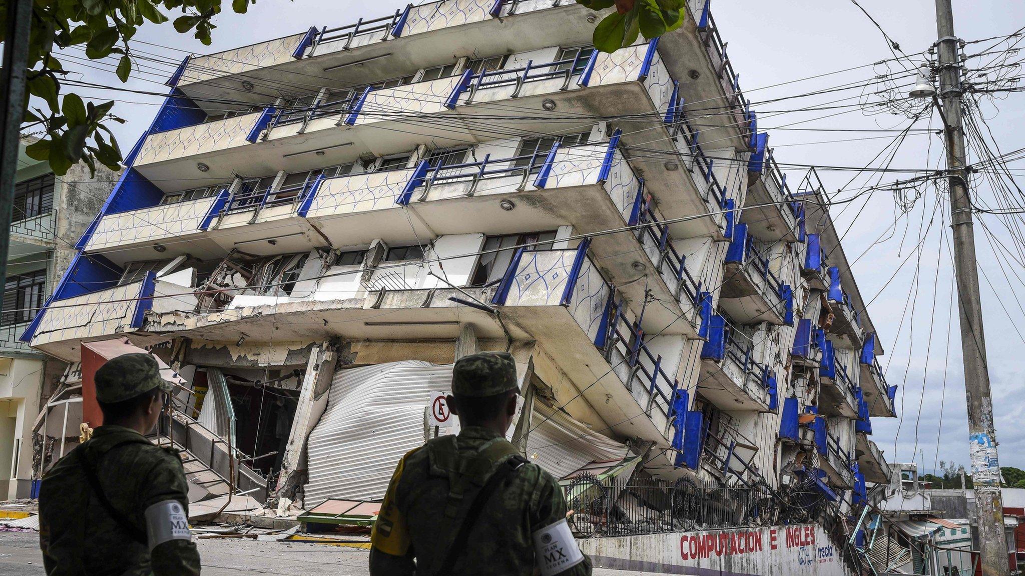 Soldiers stand guard by a hotel which collapsed in the earthquake in Matias Romero, Oaxaca State, on September 8, 2017