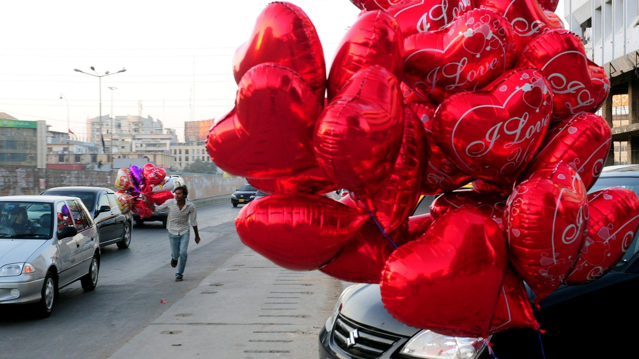 File photo: Heart shaped balloons on a street in Karachi, 14 February 2011