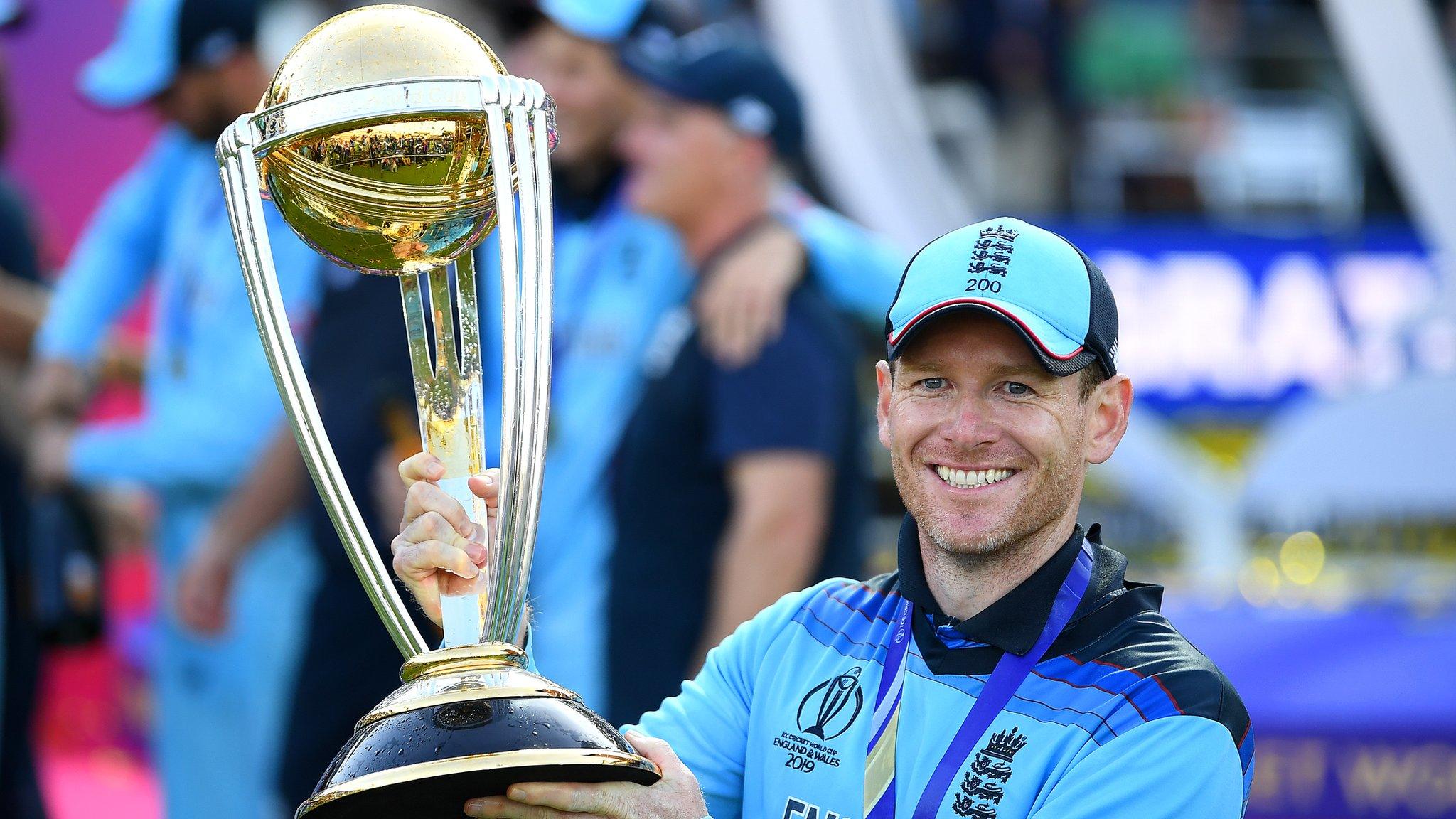 England captain Eoin Morgan smiles as he holds up the World Cup trophy