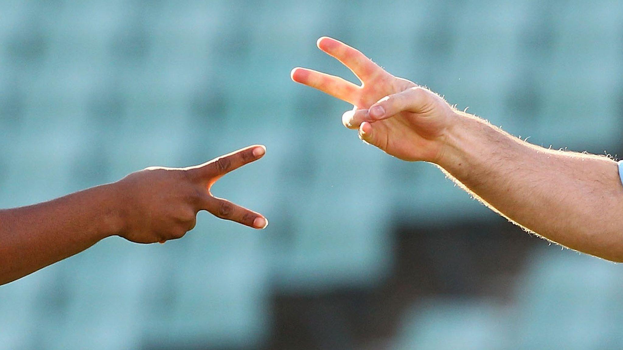 Two people playing rock, paper, scissors